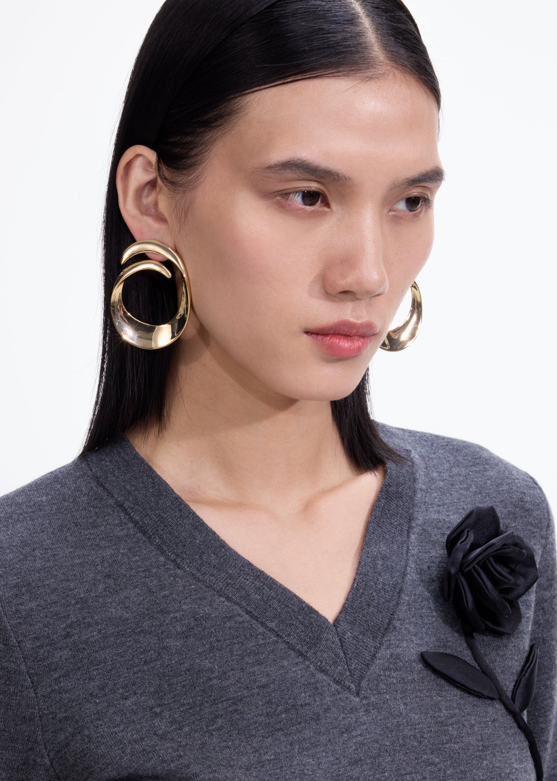 A photo of the Gold Swirl Earrings