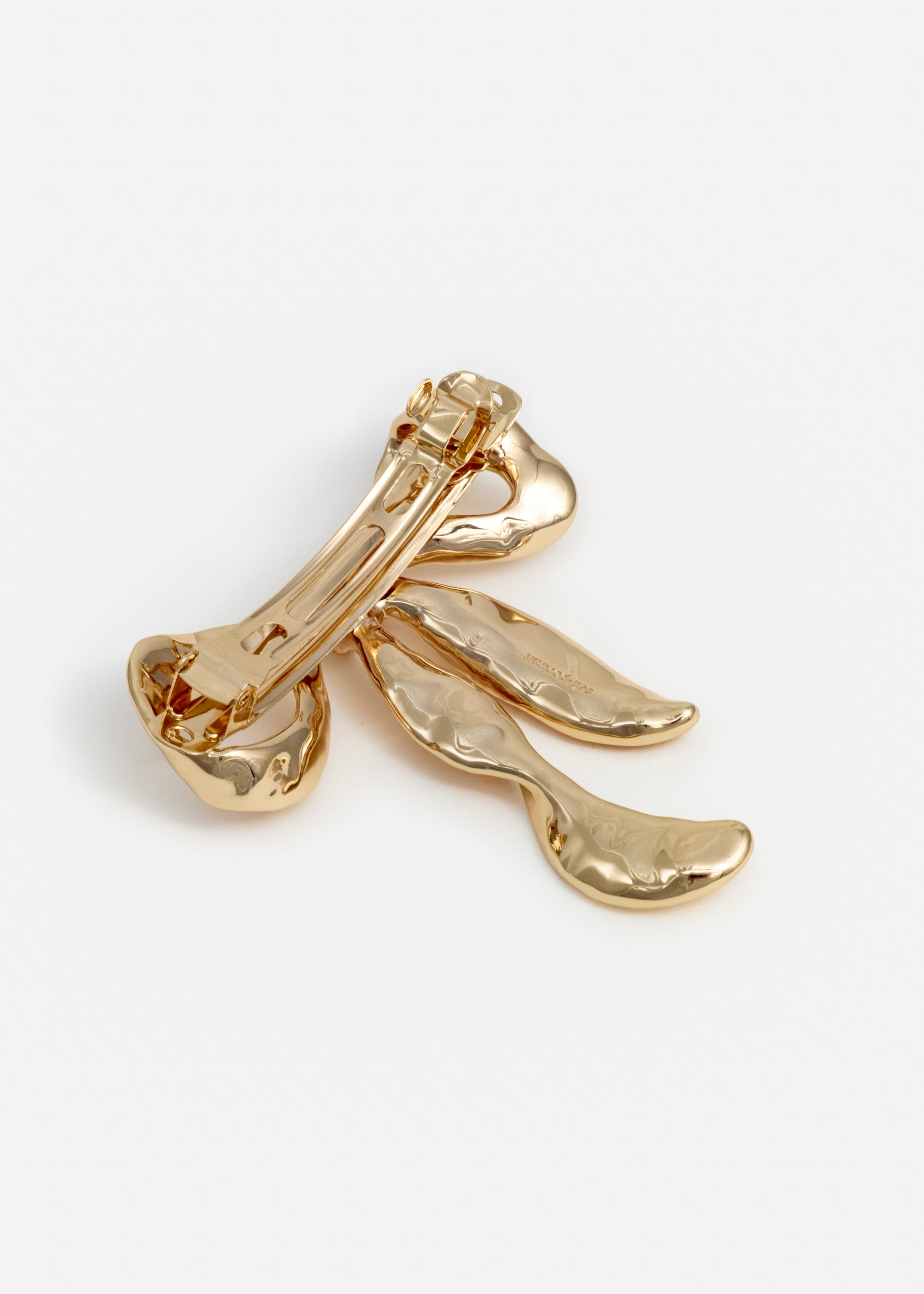 A photo of the Mottled Gold Bow Hairclip