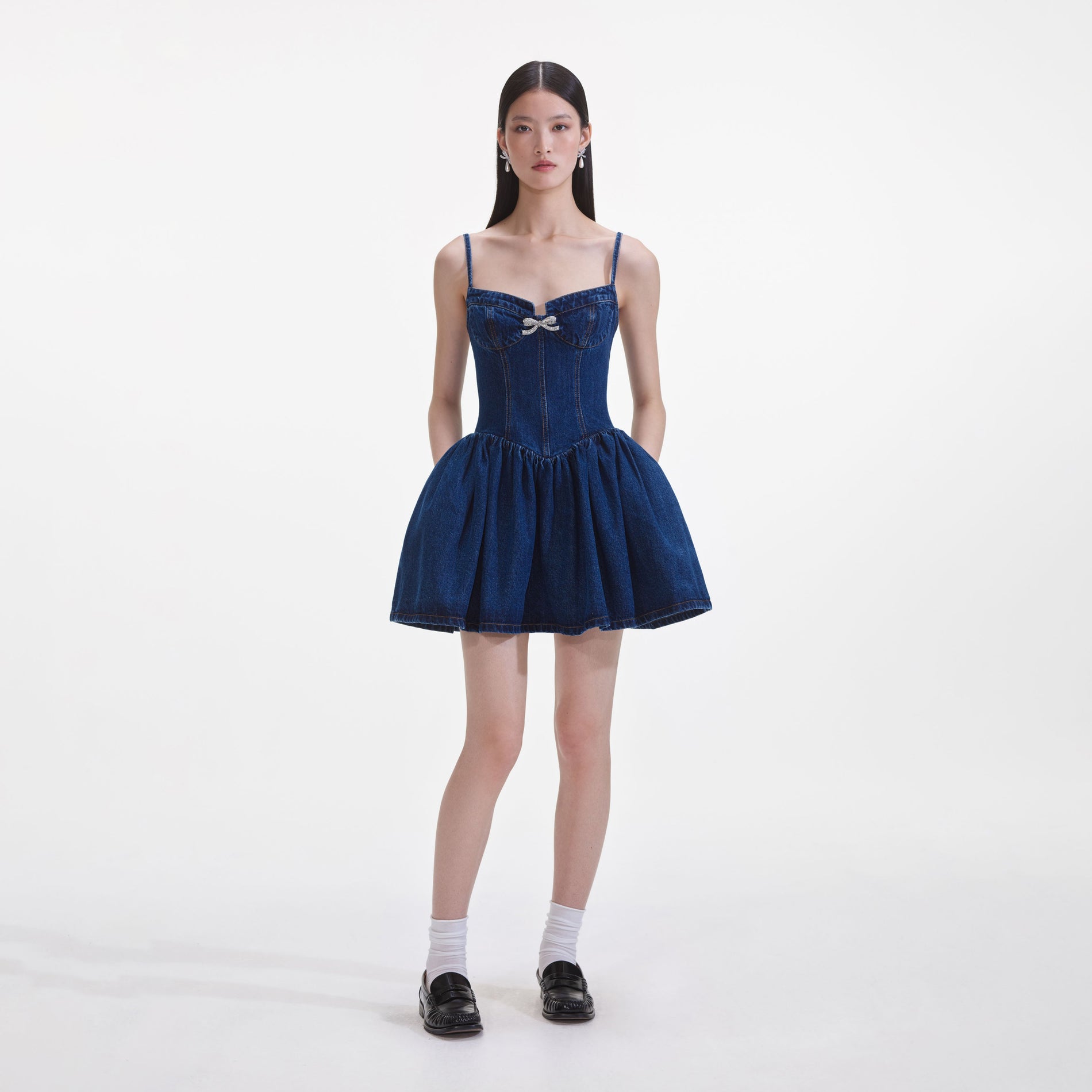 Front view of a woman wearing the Denim Diamante Bow Sweetheart Mini Dress
