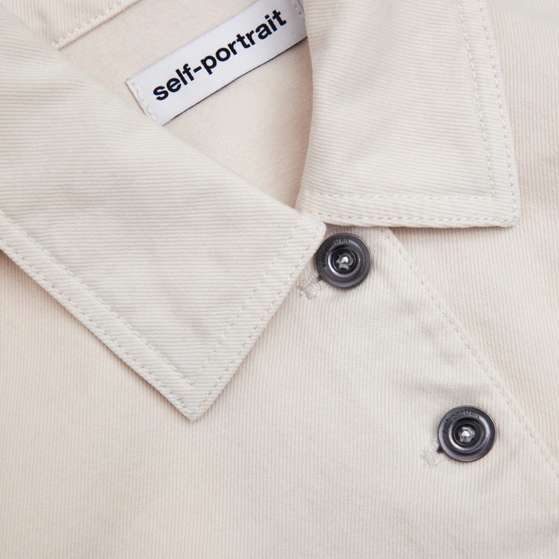 Side view of a woman wearing the Cream Denim Jacket