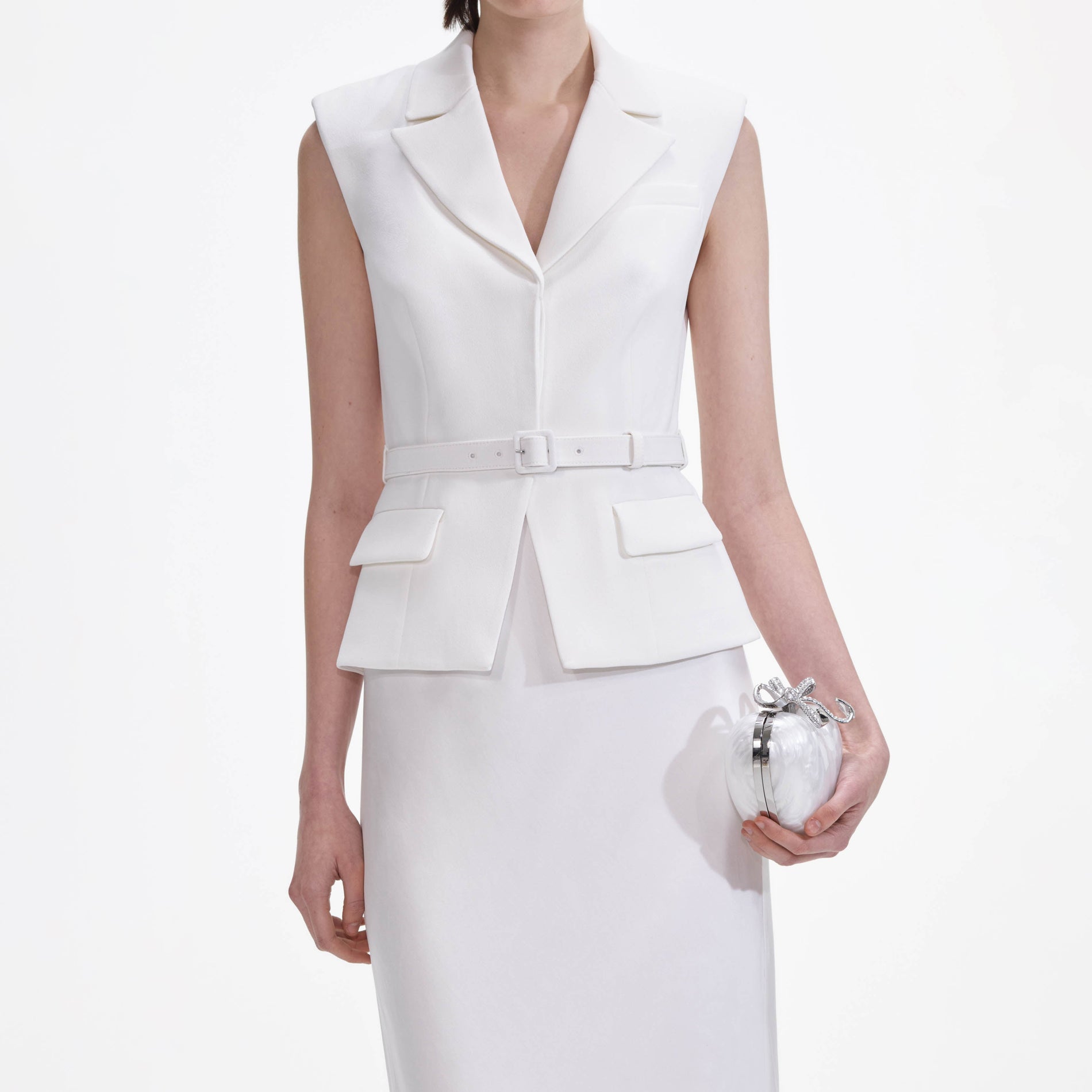 A close up of a woman wearing the White Crepe Maxi Dress