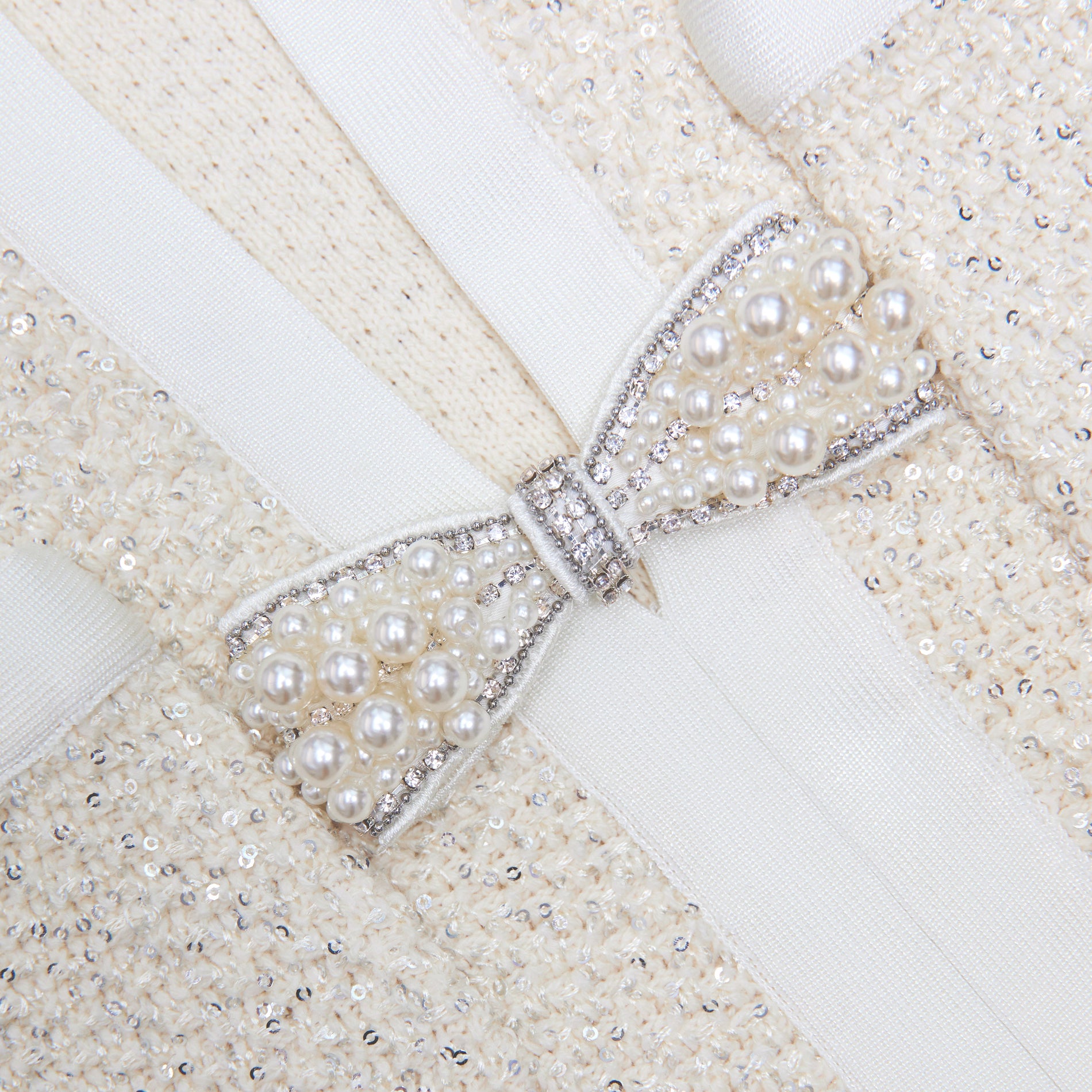 Side view of a woman wearing the Cream Sequin Knit Top