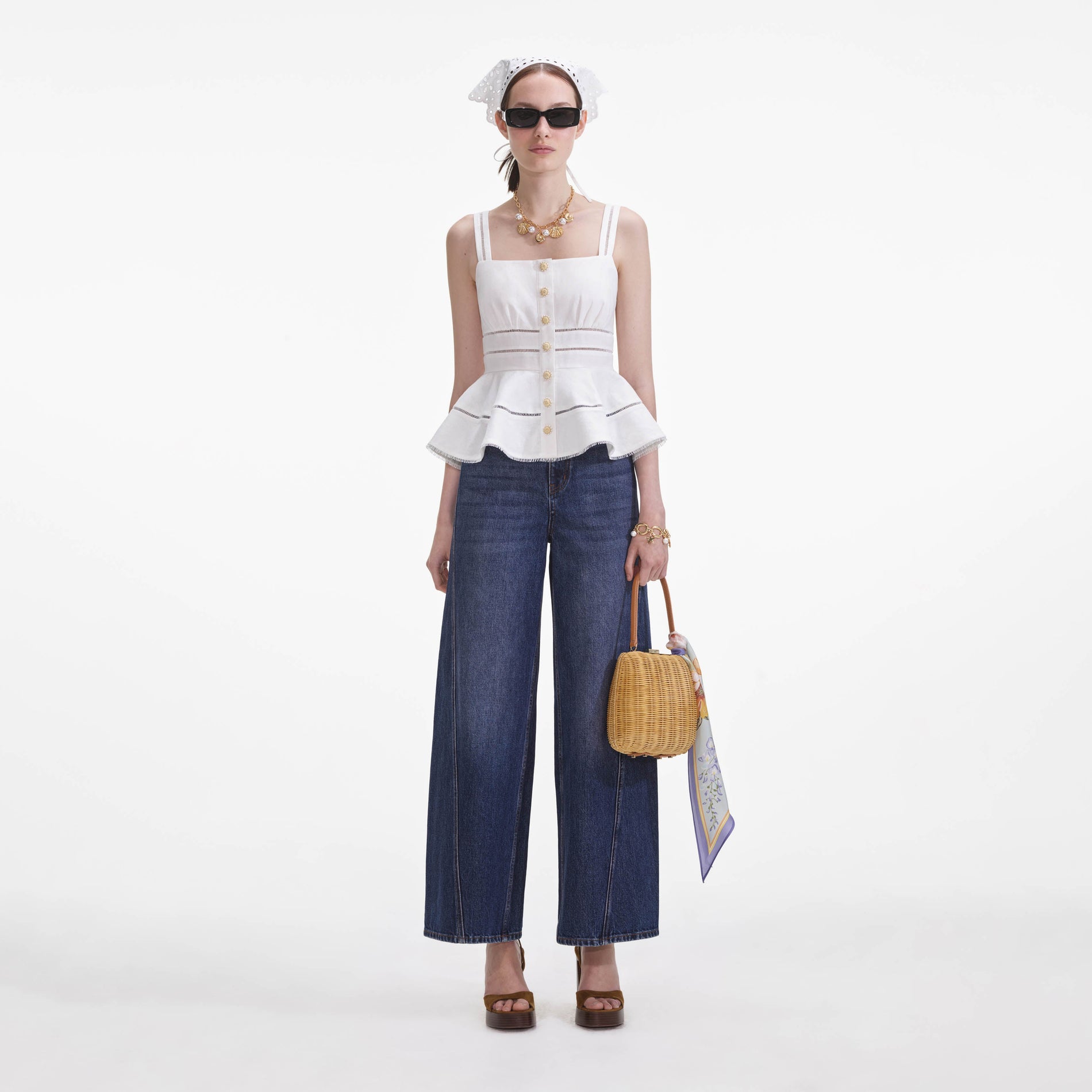 Front view of a woman wearing the White Linen Peplum Top