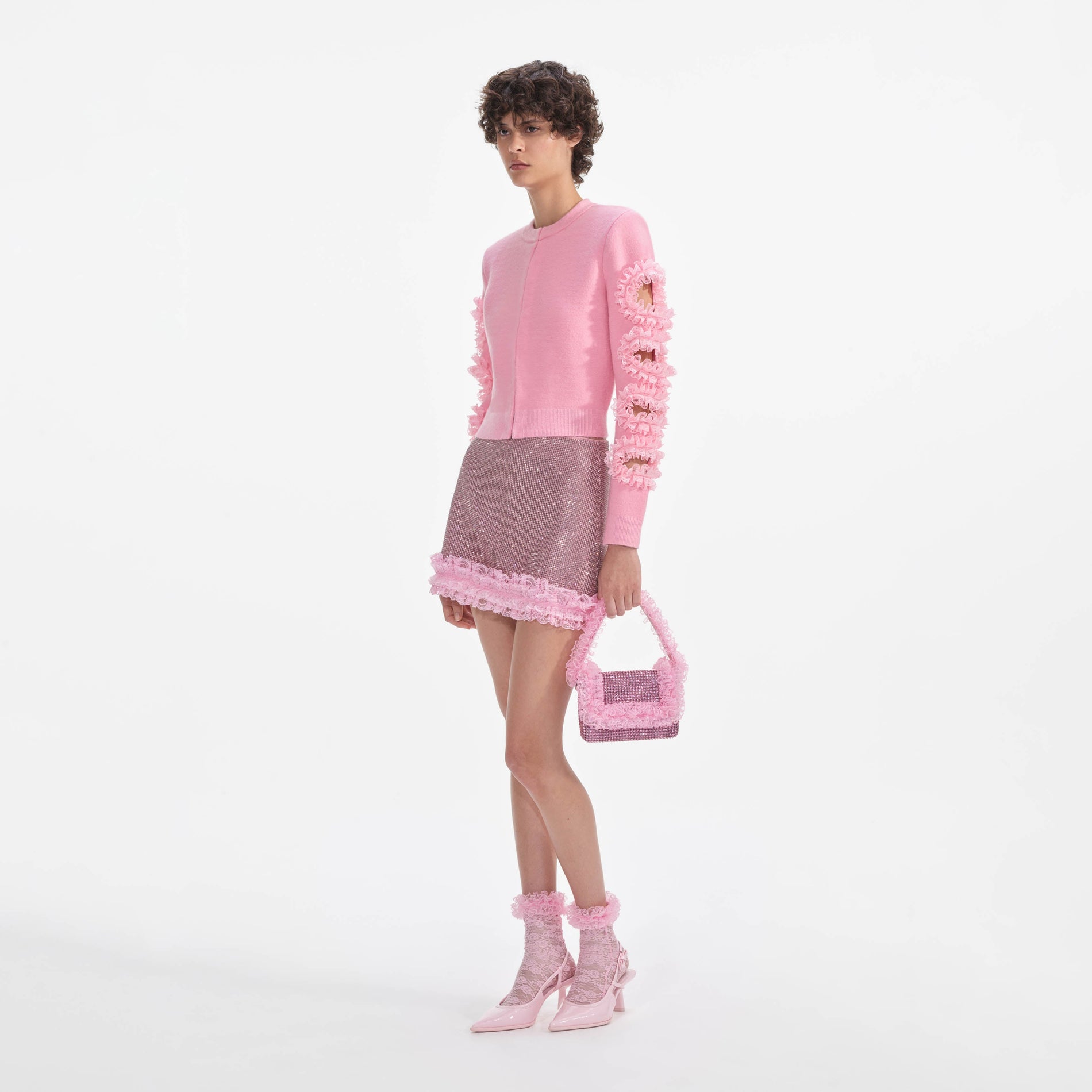 Side view of a woman wearing the Pink Cut Out Lace Detail Cardigan