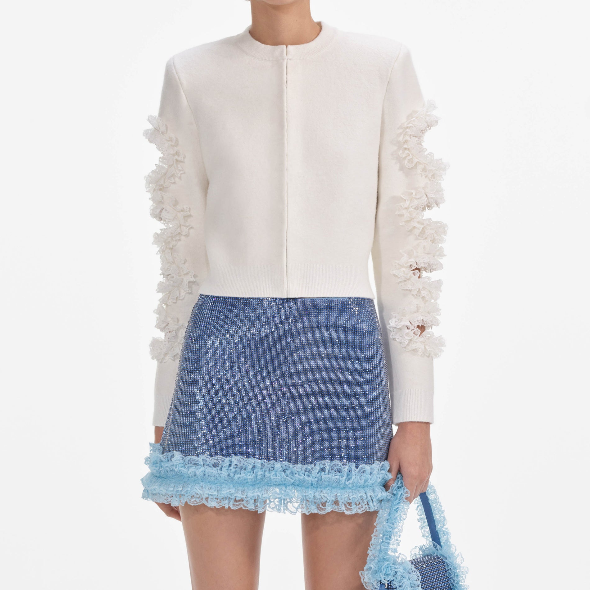 A close up of a woman wearing the White Cut Out Lace Detail Cardigan