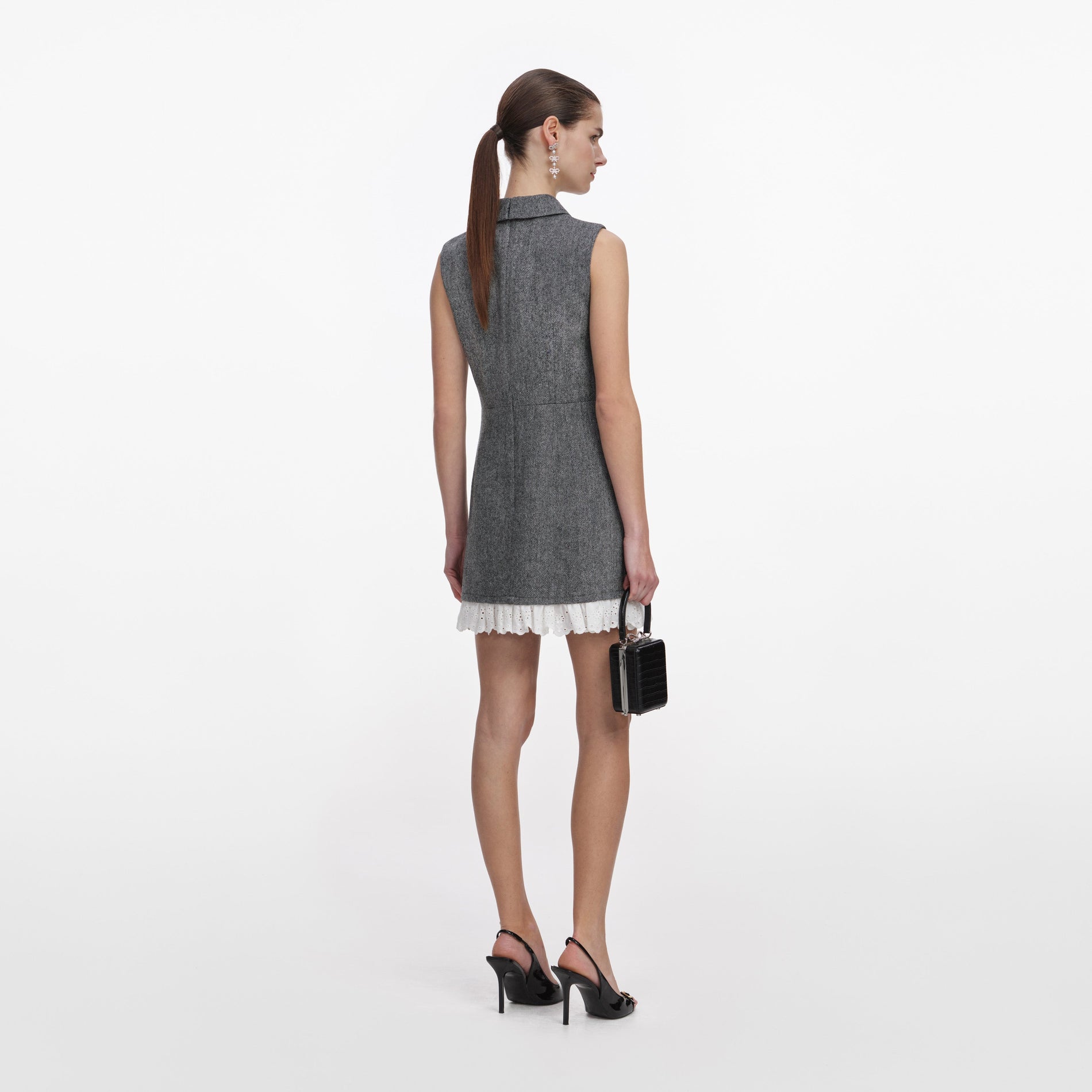 Back view of a woman wearing the Grey Herringbone Mini Dress