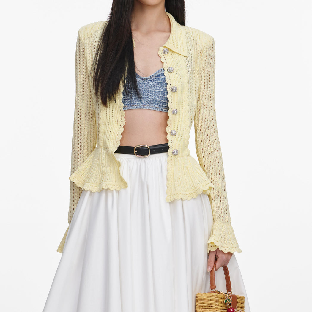 A close up of a woman wearing the Yellow Pointelle Cardigan