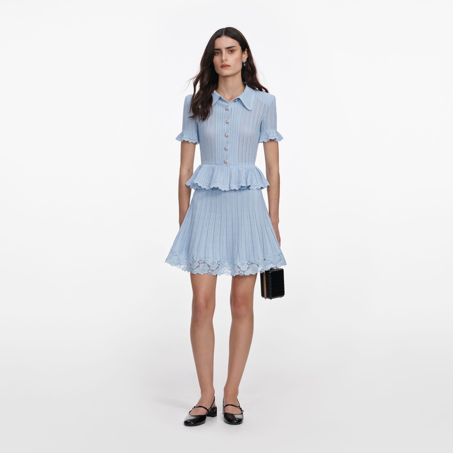 Front view of a woman wearing the Blue Pointelle Peplum Knit Mini Dress