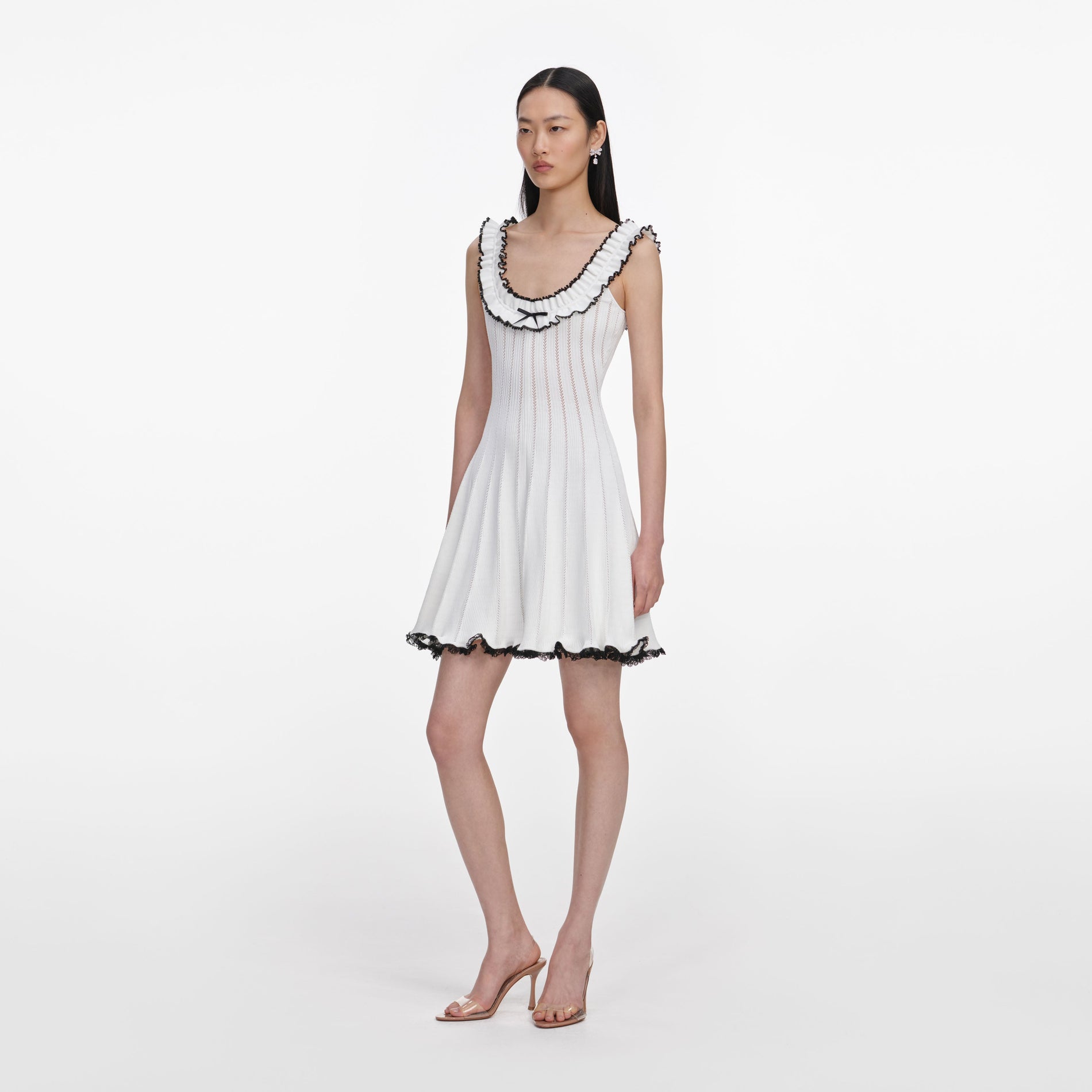 Side view of a woman wearing the White Contrast Trim Knit Mini Dress