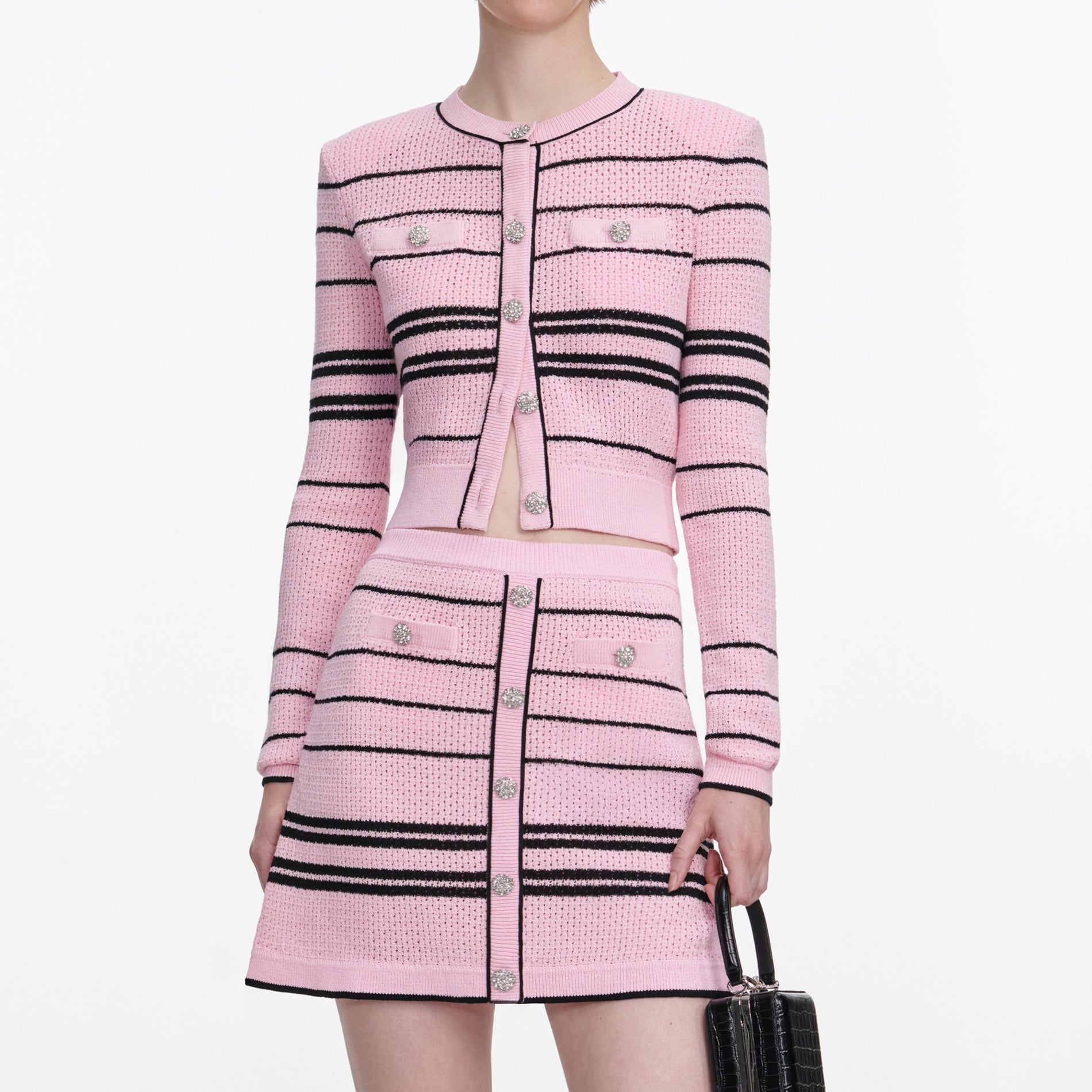 A close up of a woman wearing the Pink Stripe Knit Mini Skirt