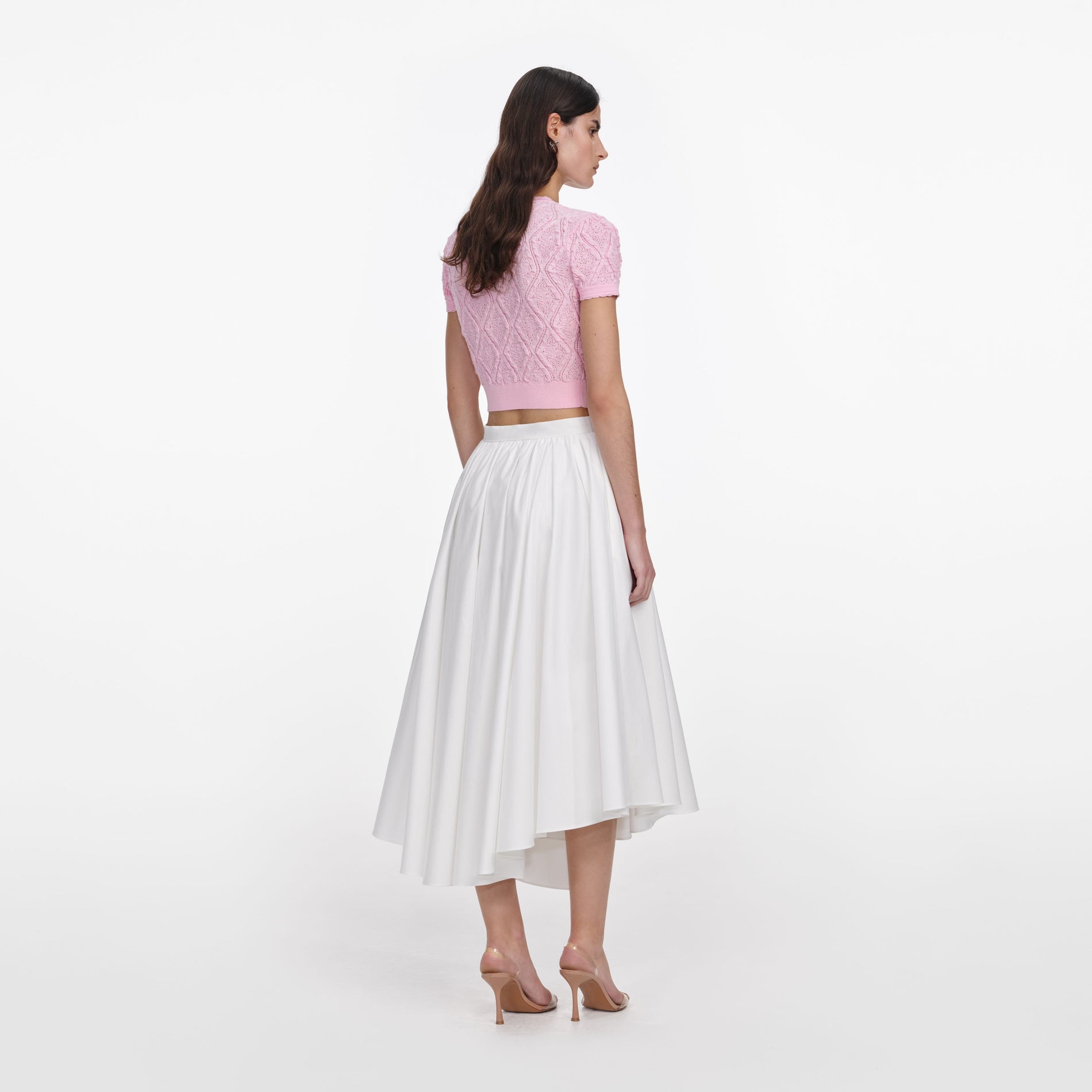 Back view of a woman wearing the Pink Pointelle Knit Top