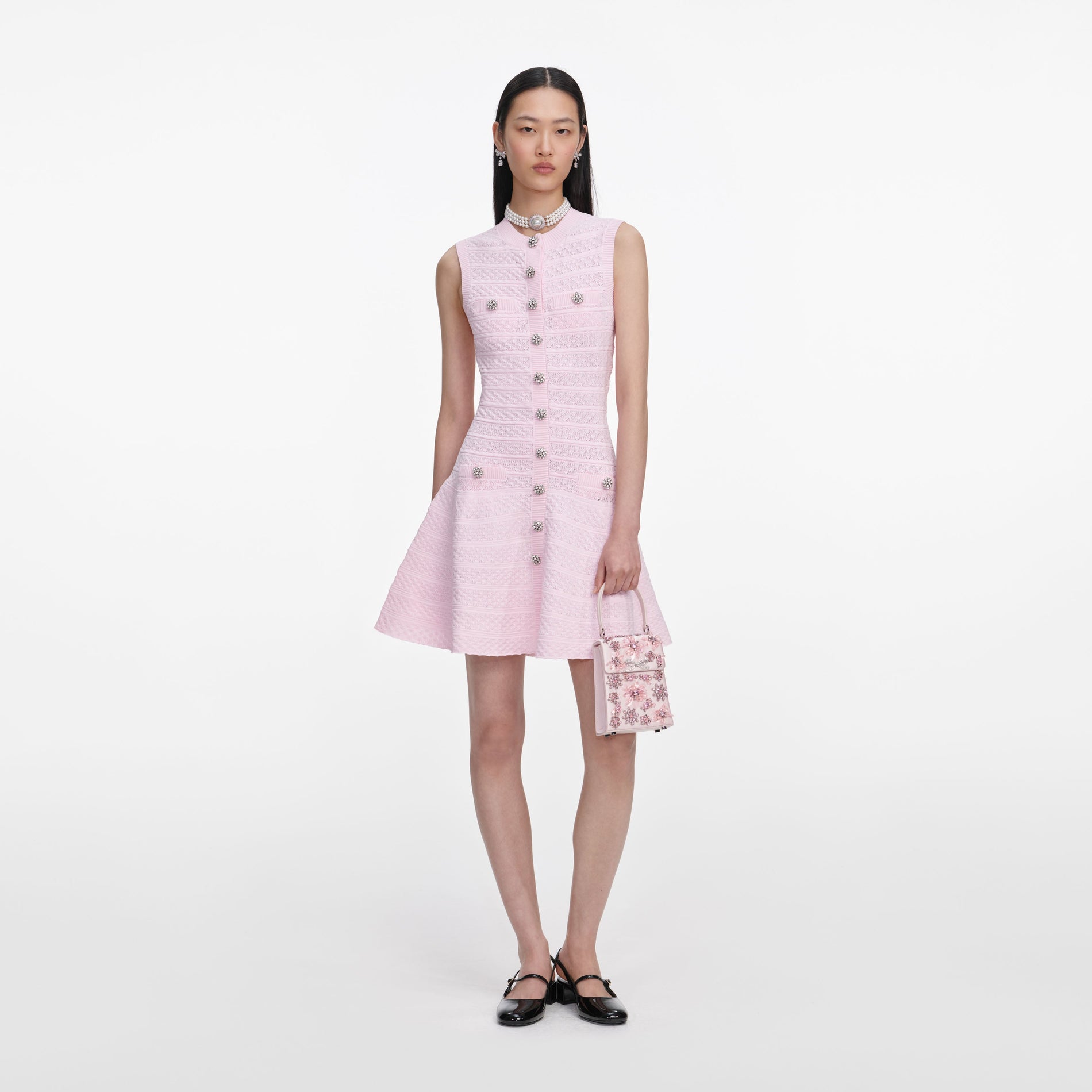 Front view of a woman wearing the Pink Pointelle Diamante Knit Mini Dress