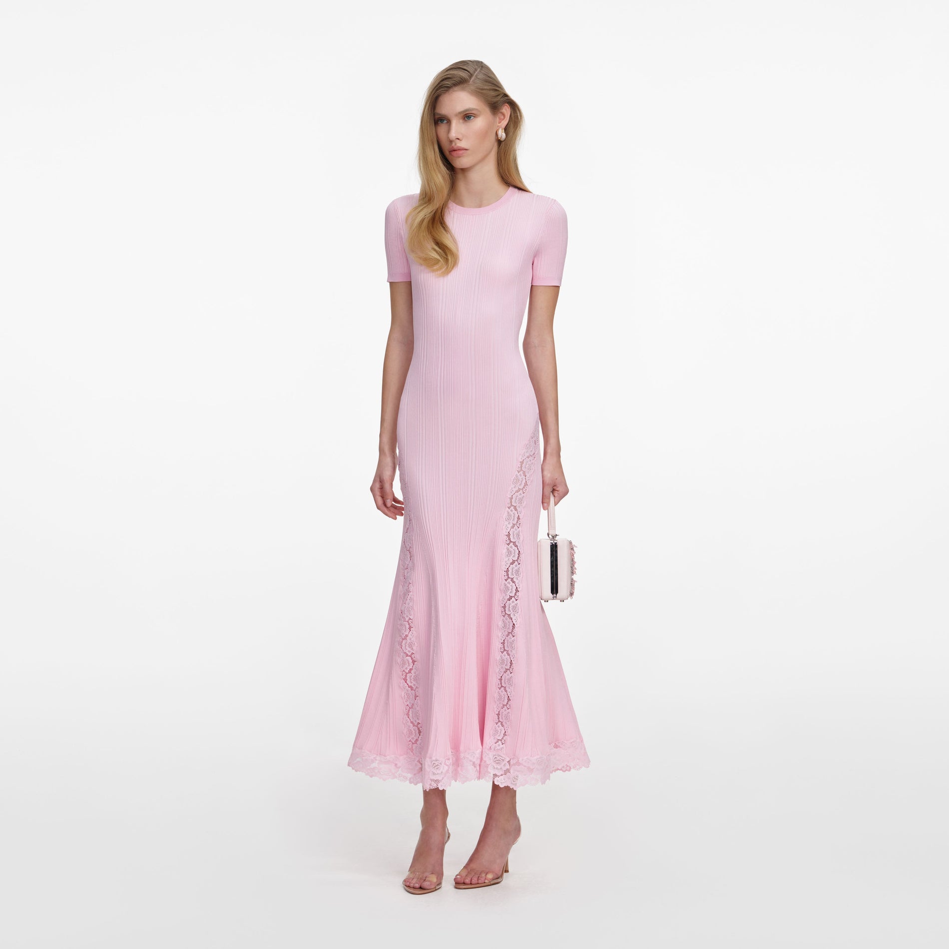 Side view of a woman wearing the Pink Knit Lace Insert Midi Dress