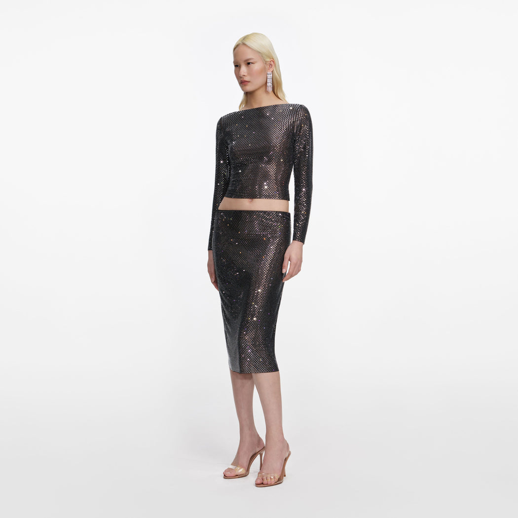 Side view of a woman wearing the Gunmetal Rhinestone Midi Skirt