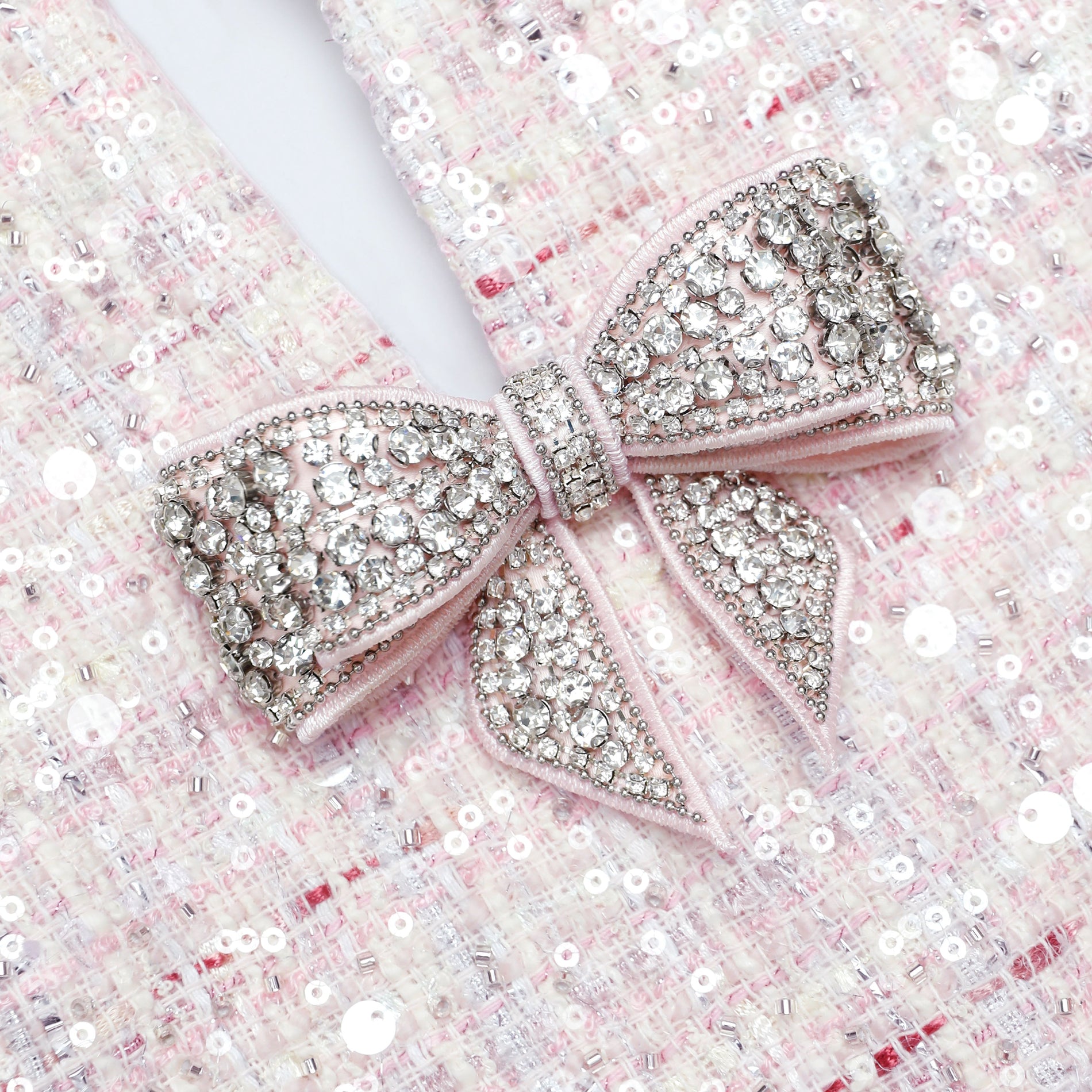 A close up of the fabric for the Pink Sequin Boucle Bow Mini Dress