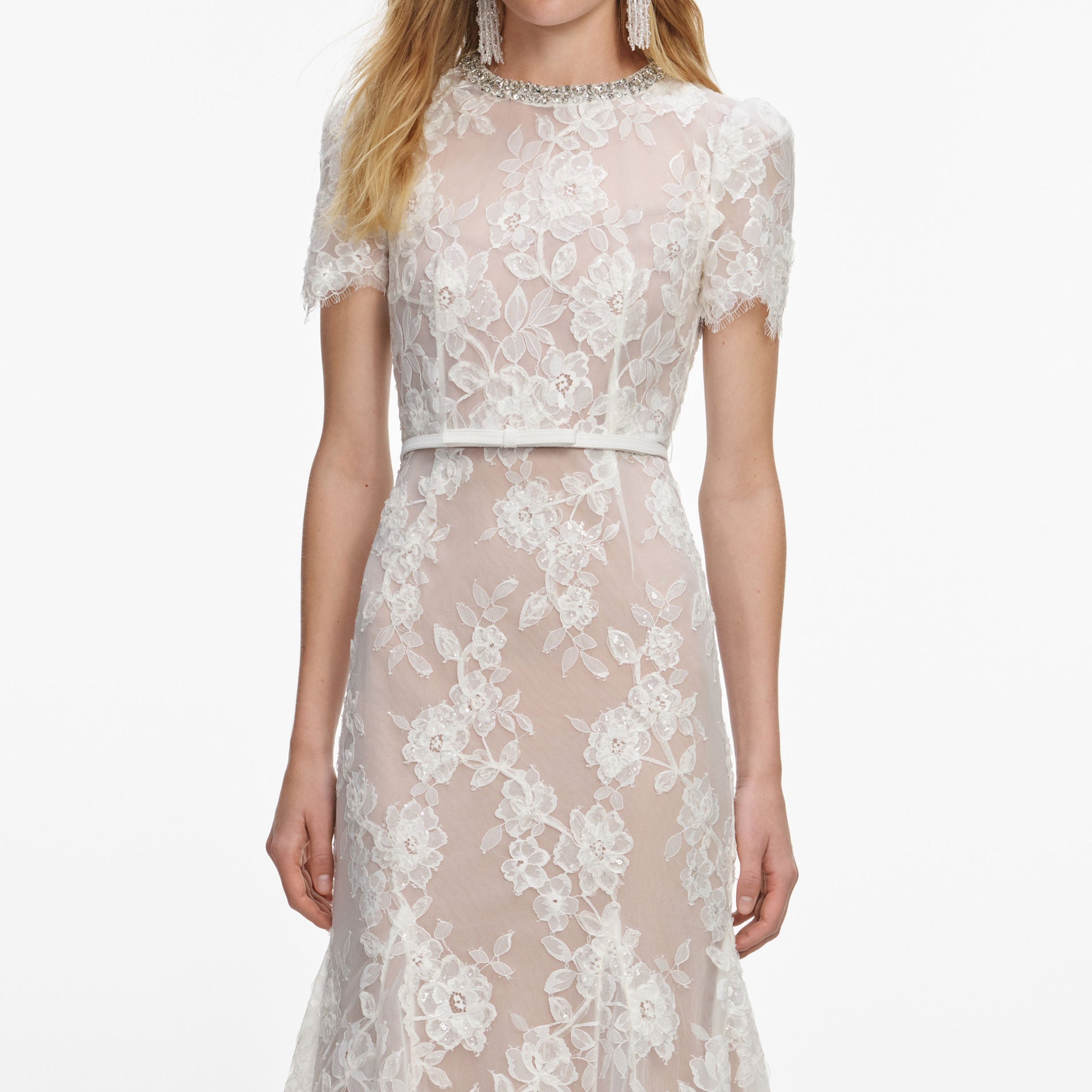 A close up of a woman wearing the White Sequin Lace Midi Dress