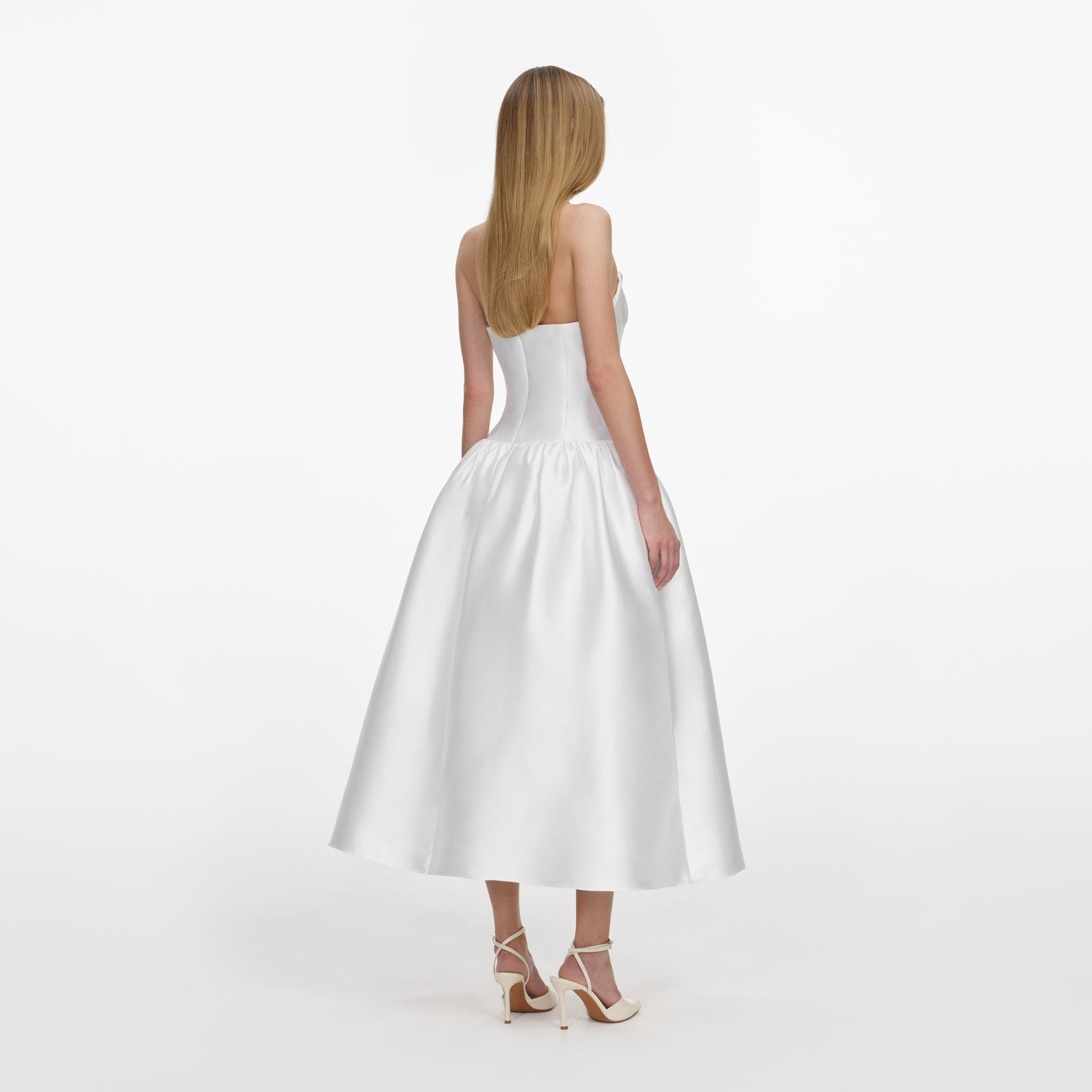 Back view of a woman wearing the White Taffeta Strapless Midi Dress