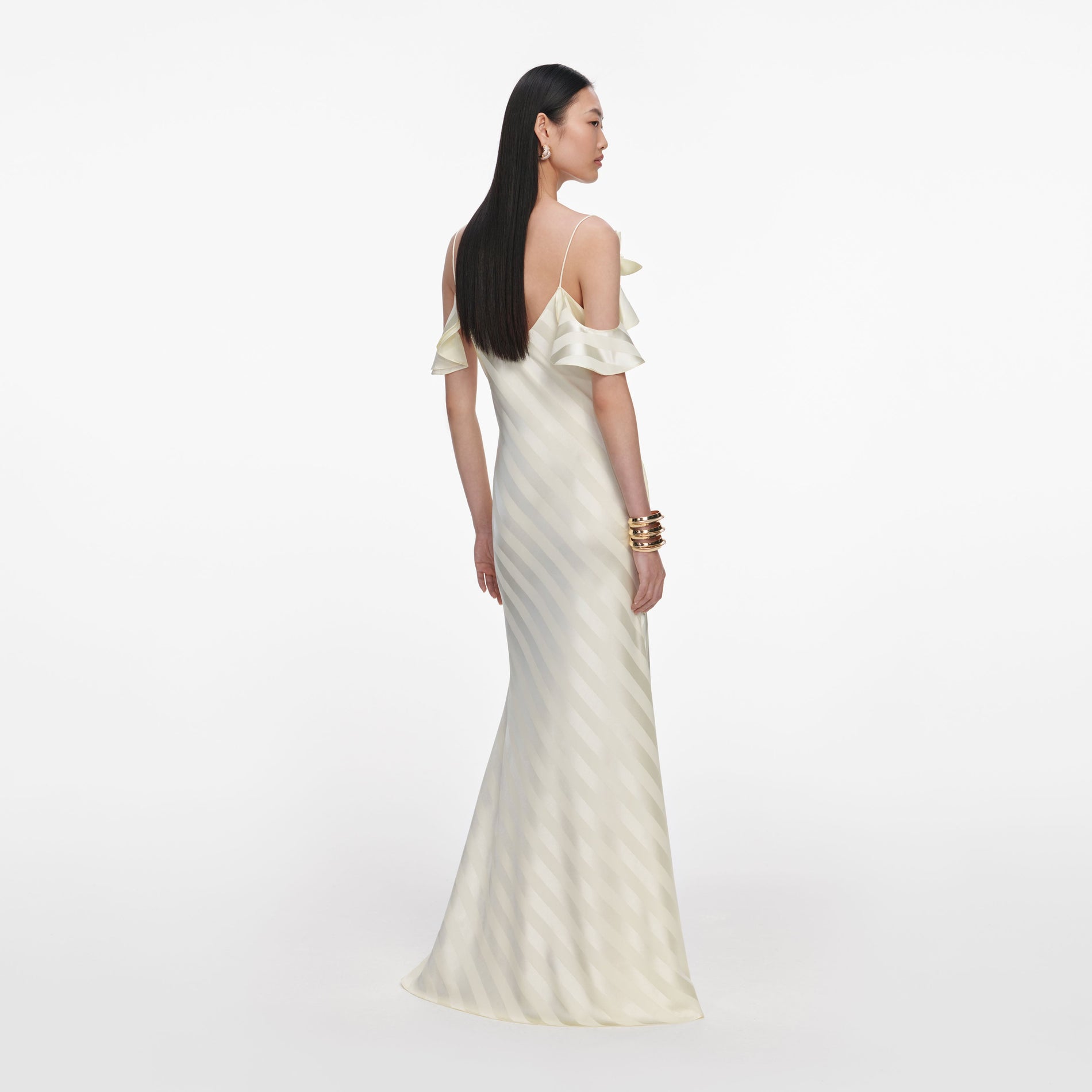 Back view of a woman wearing the Yellow Satin Striped Maxi Dress