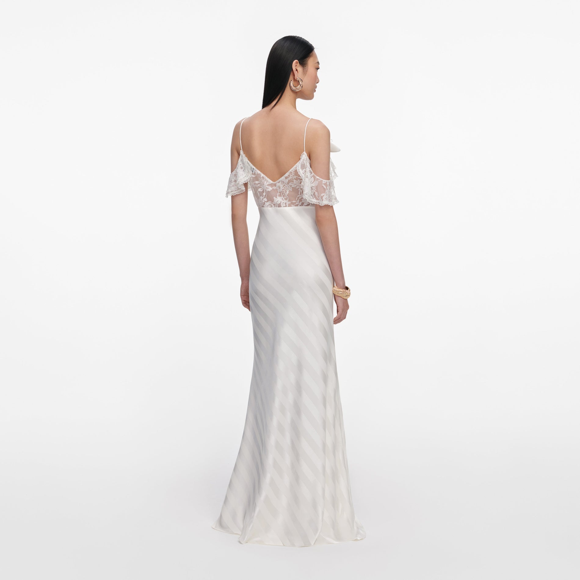 Back view of a woman wearing the Cream Satin Striped Maxi Dress
