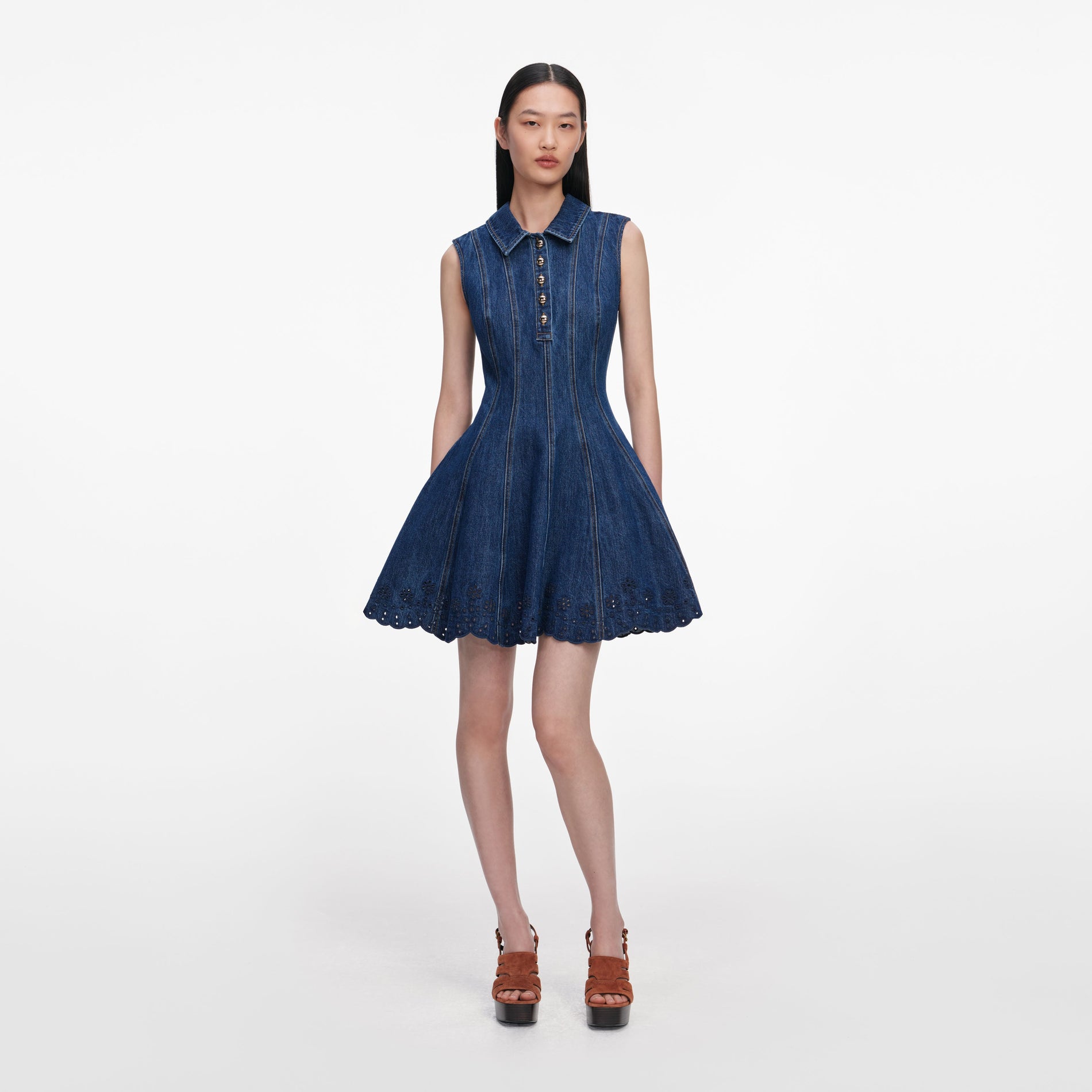 Front view of a woman wearing the Denim Broderie Mini Dress