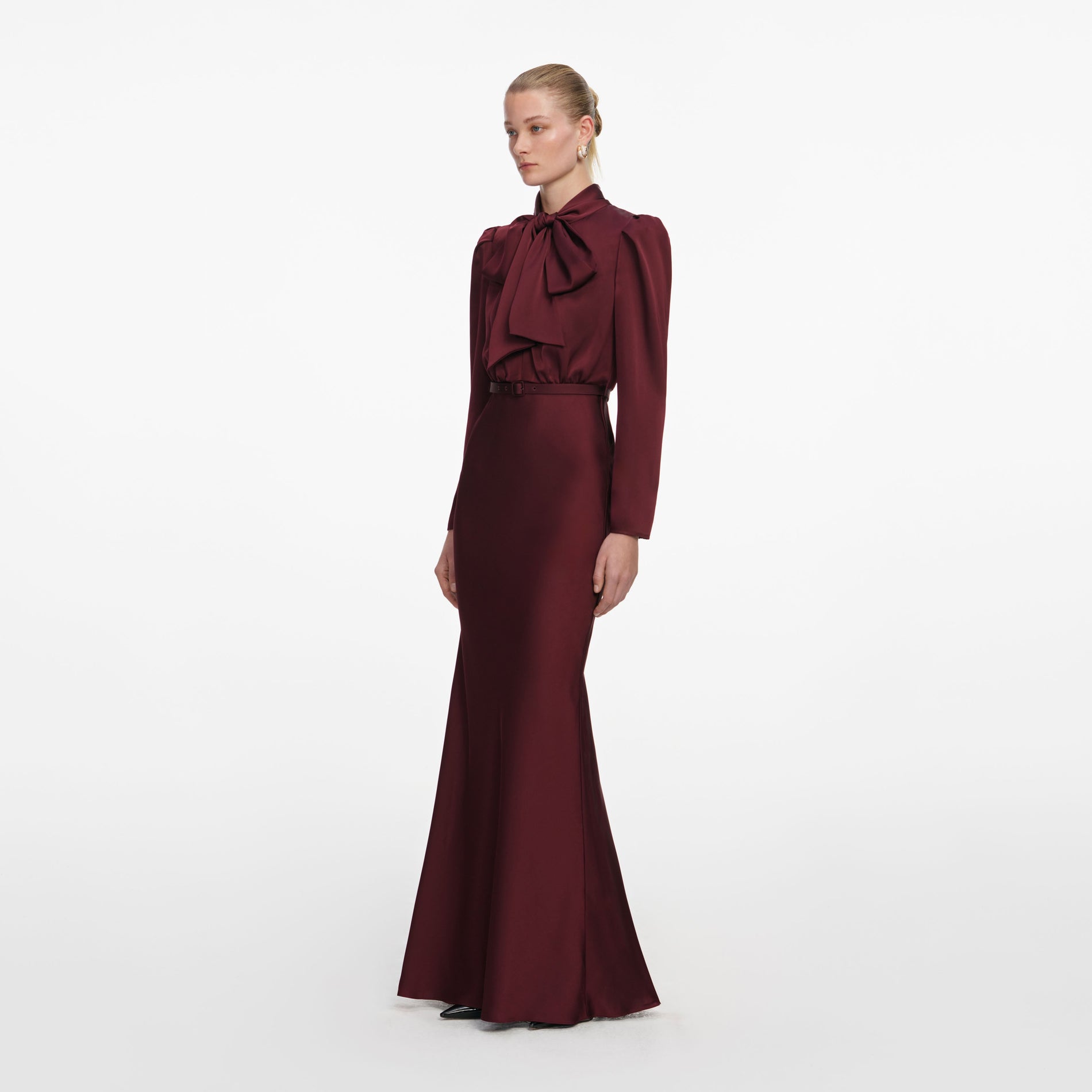 Side view of a woman wearing the Burgundy Tie Neck Satin Maxi Dress