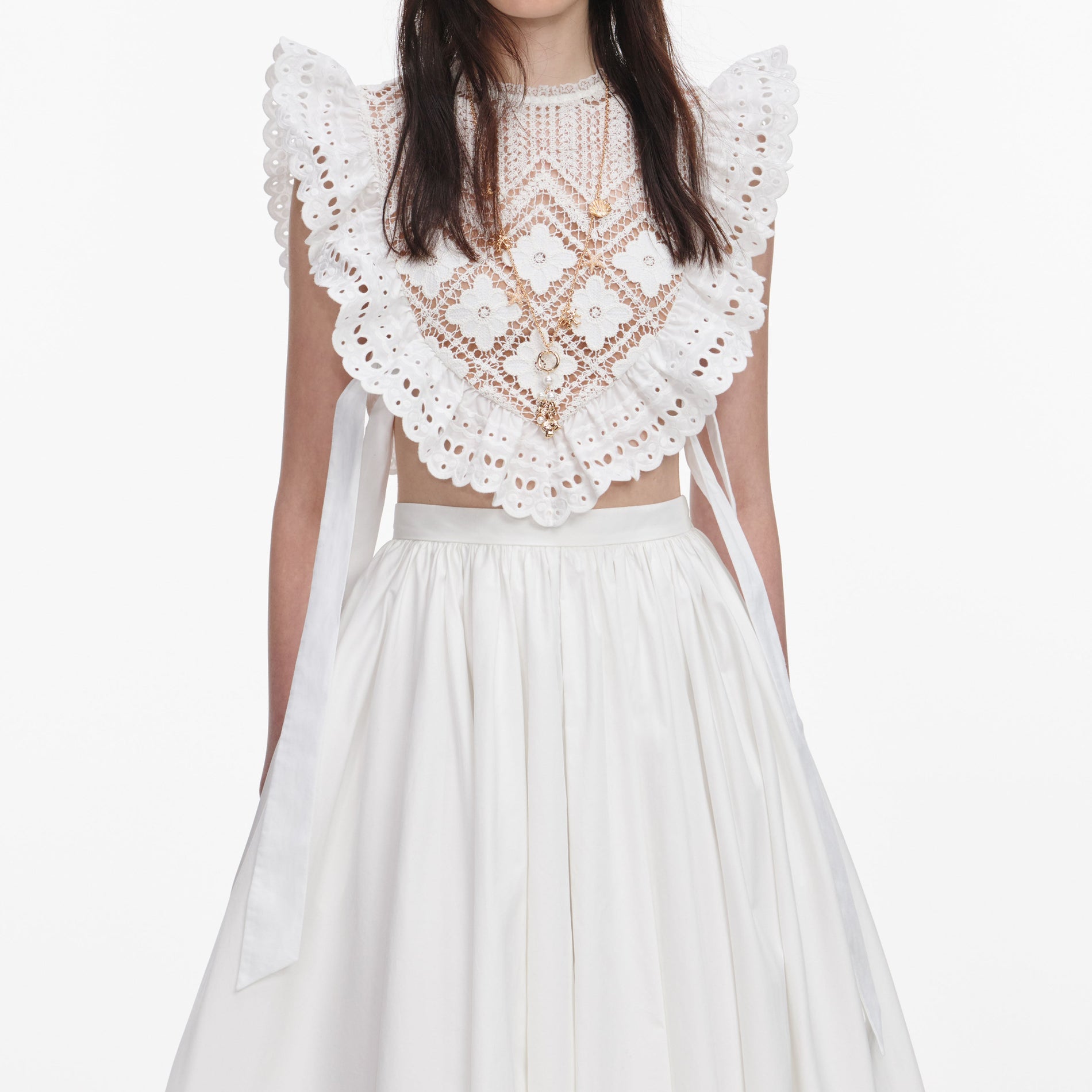 A close up of a woman wearing the White Crochet Lace Crop Top