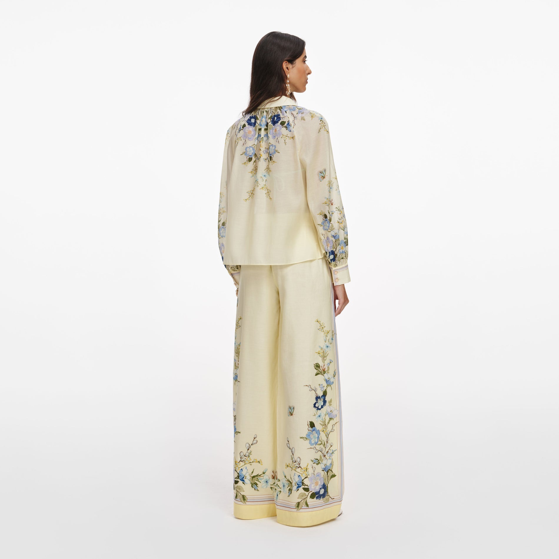 Back view of a woman wearing the Yellow Floral Organza Trousers