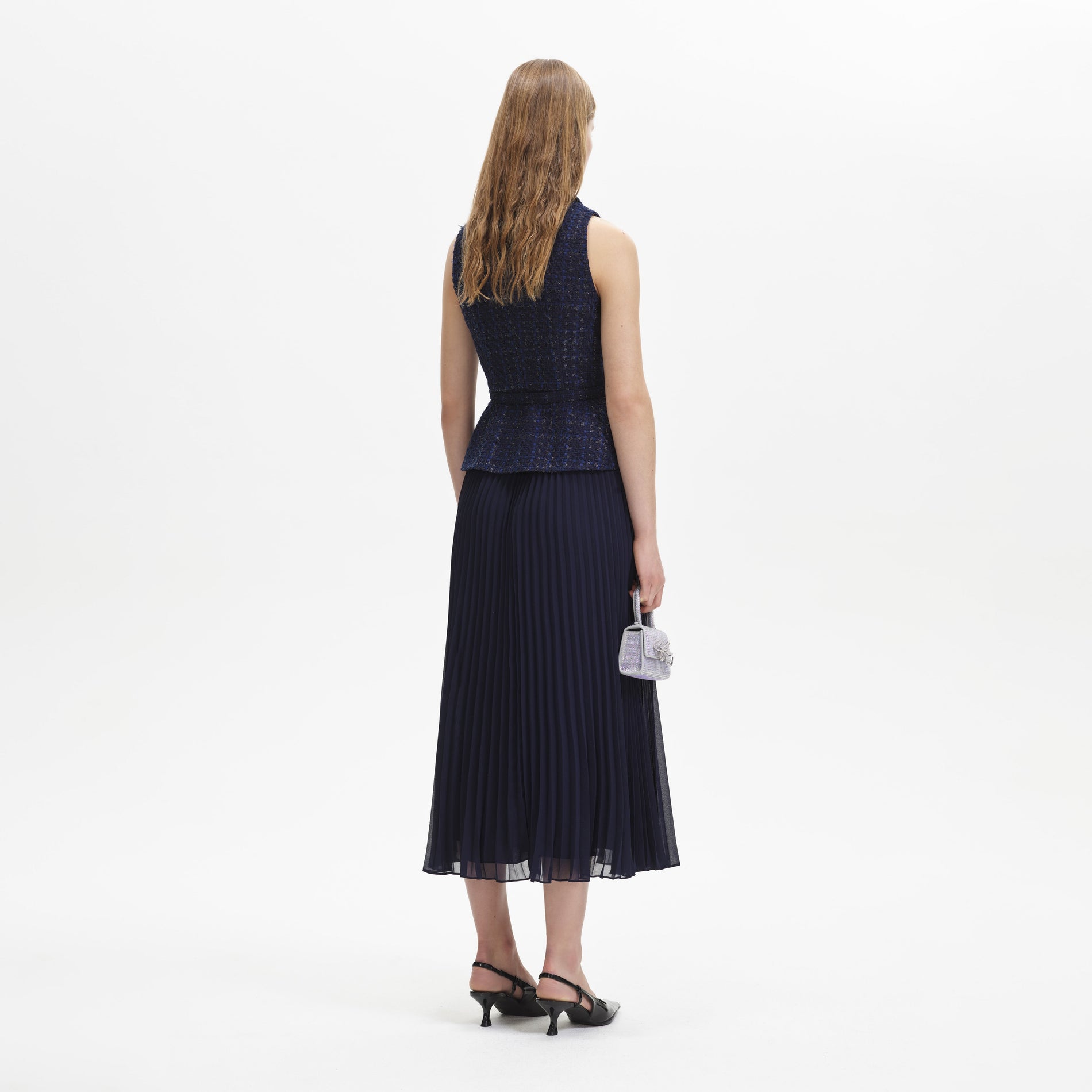 A woman wearing the Navy Metallic Boucle Chiffon Midi Dress