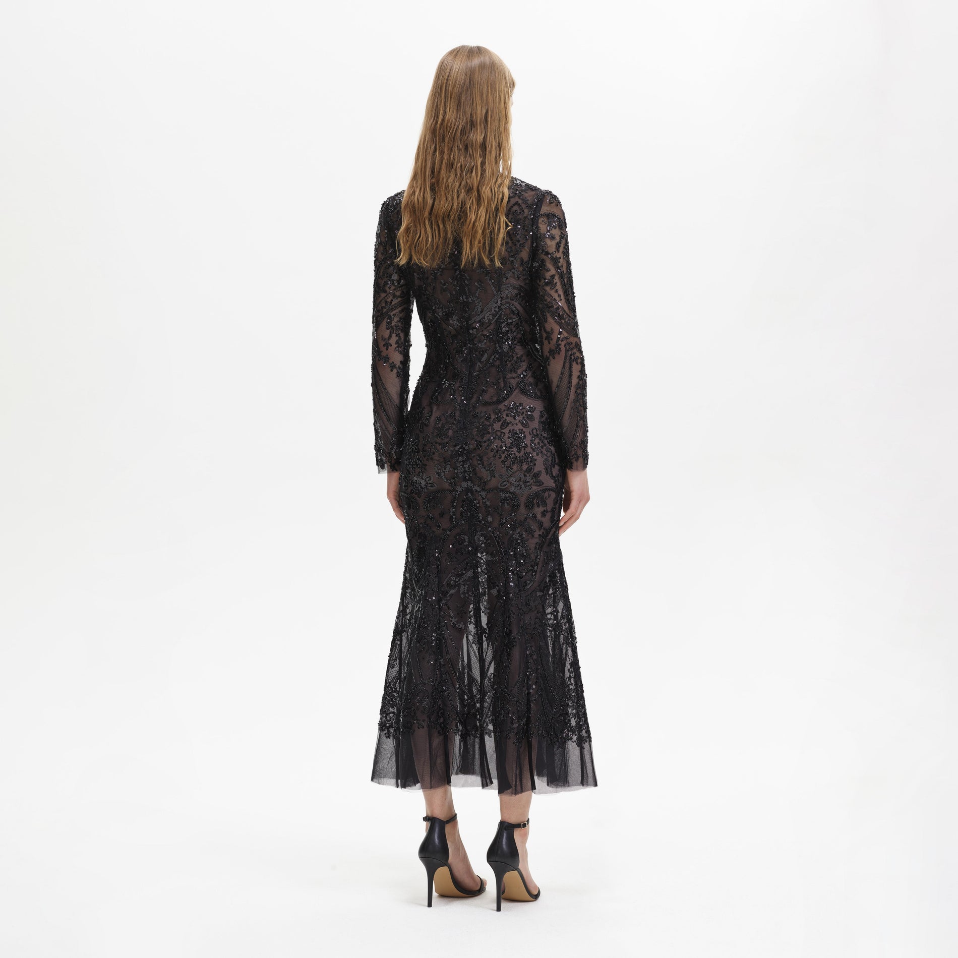 Back view of a woman wearing the Black Paisley Sequin Midi Dress