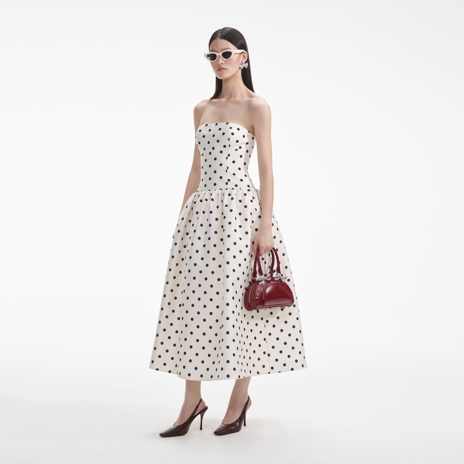 Back view of a woman wearing the White Cream Polka Dot Taffeta Midi Dress