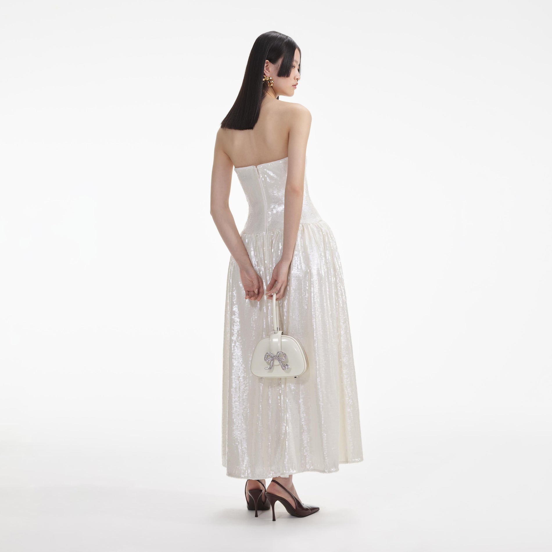 Back view of a woman wearing the White Cream Sequin Bandeau Midi Dress