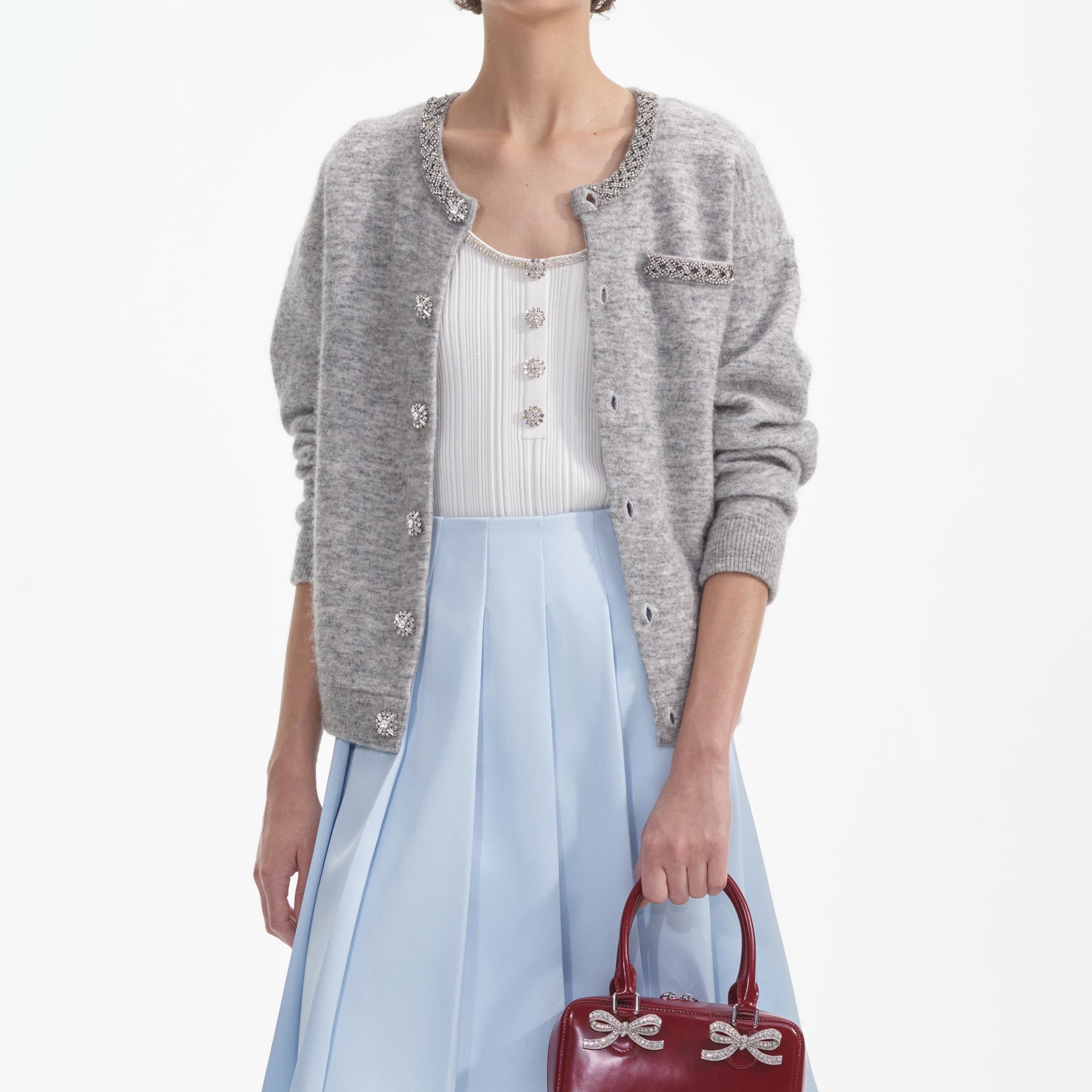 A close up of a woman wearing the Grey Melange Cardigan