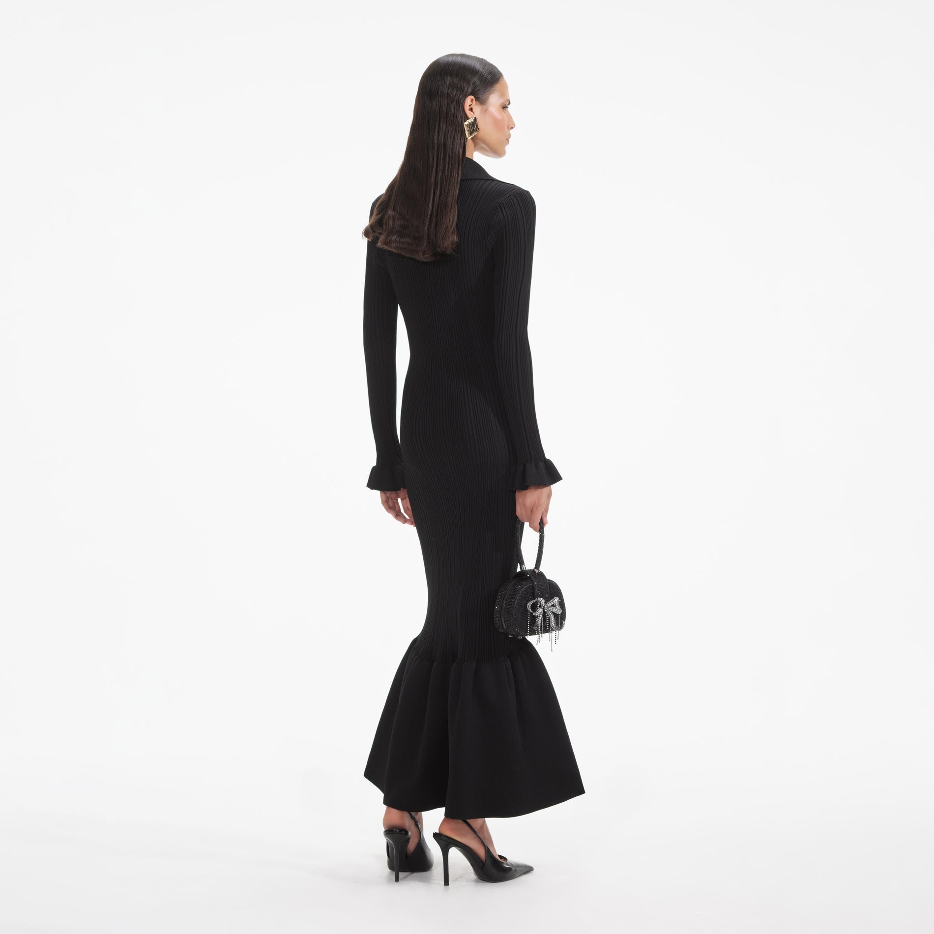 Back view of a woman wearing the White Black Ribbed Knit Fluted Midi Dress