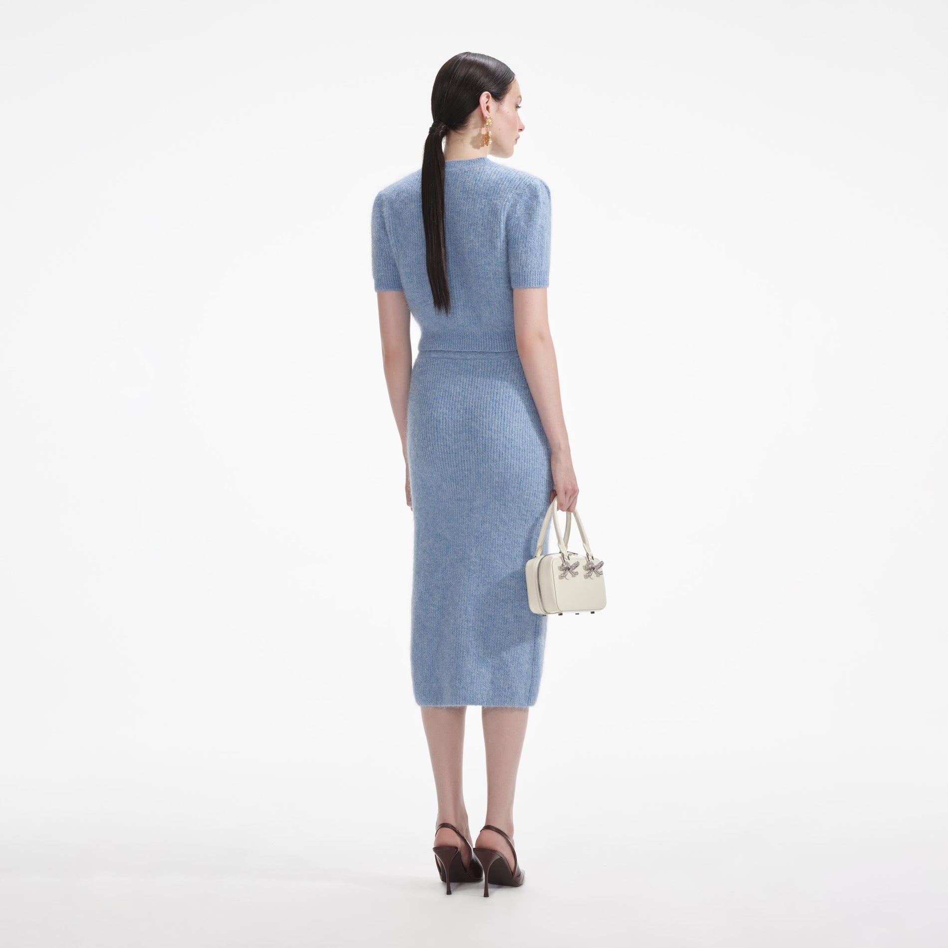 Back view of a woman wearing the White Blue Soft Knit Midi Skirt