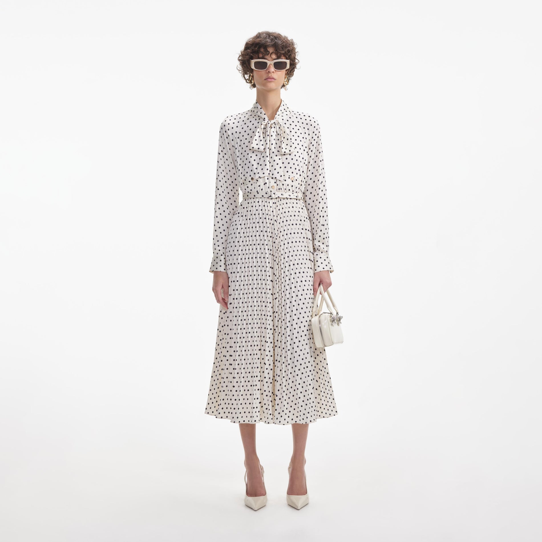 Front view of a woman wearing the Cream Polka Dot Satin Midi Dress