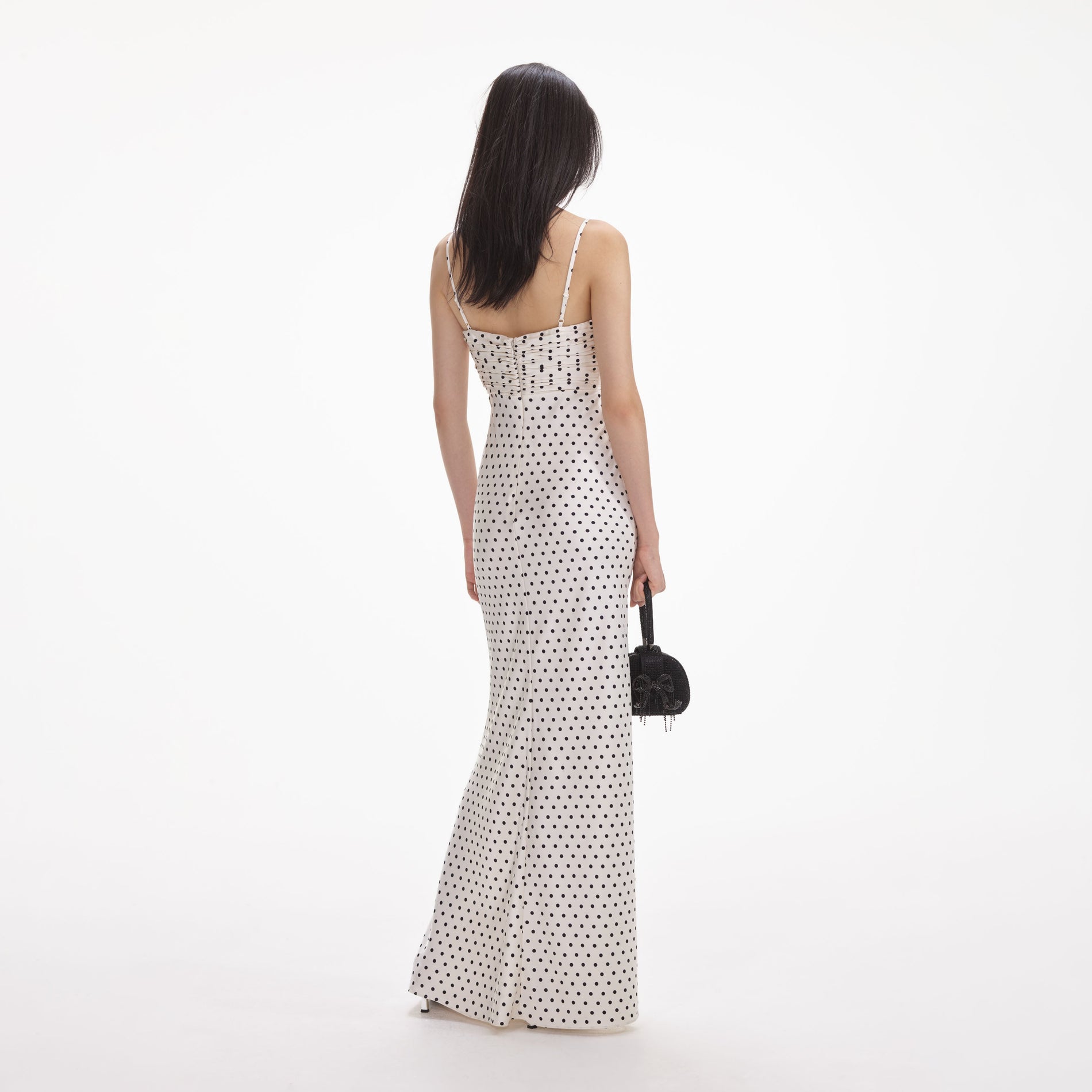 Back view of a woman wearing the White Cream Polka Dot Satin Maxi Dress