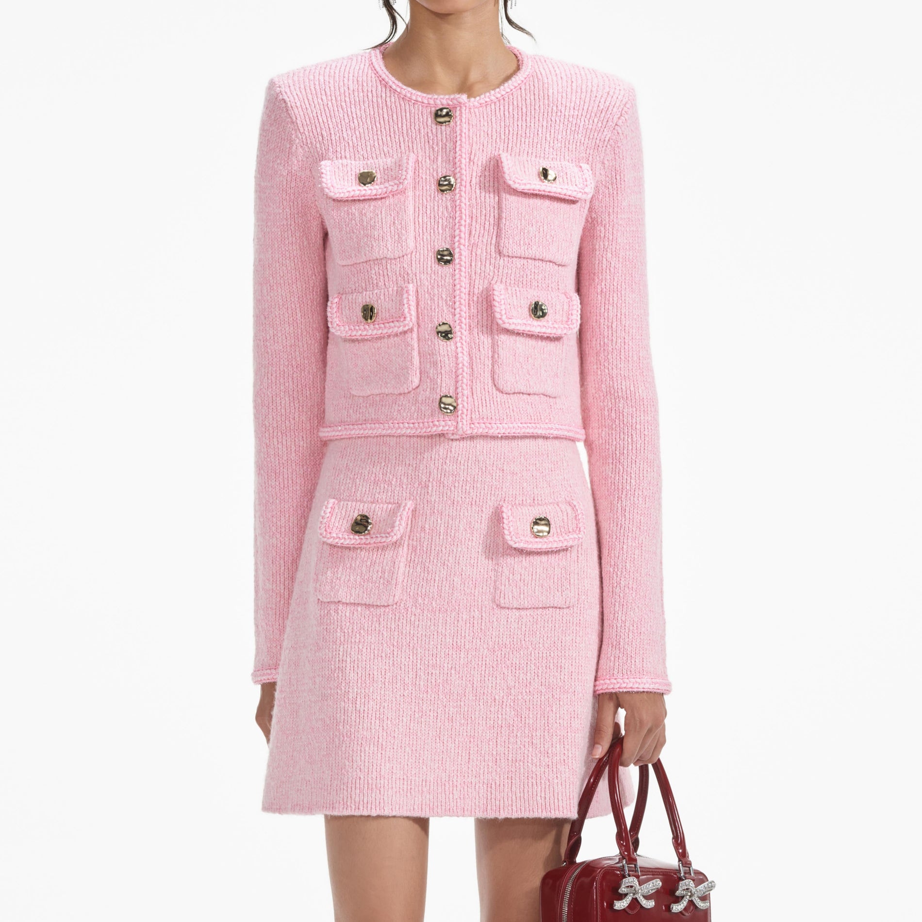 A close up of a woman wearing the Pink Melange Merino Knit Skirt