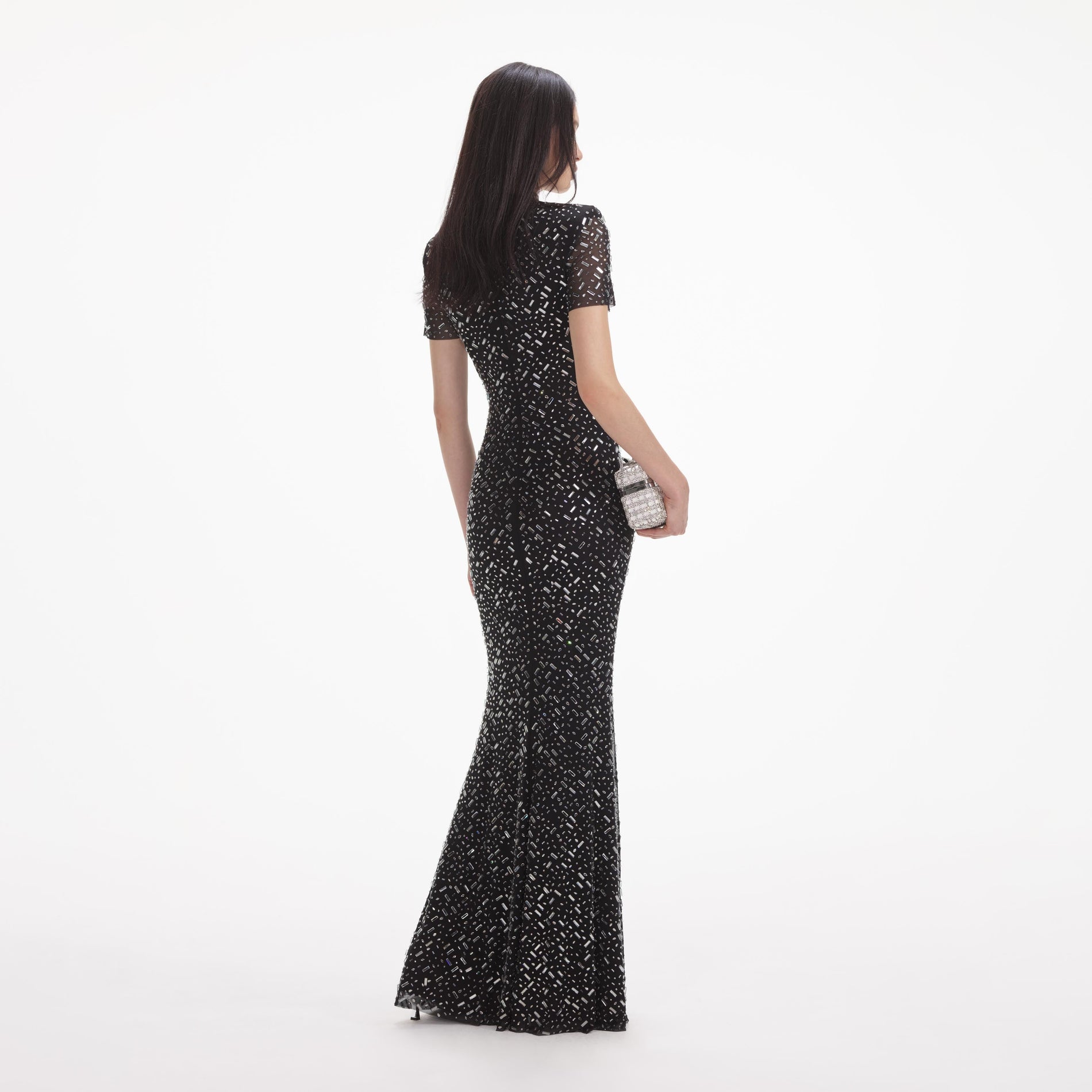 Back view of a woman wearing the White Black Square Rhinestone Mesh Maxi Dress