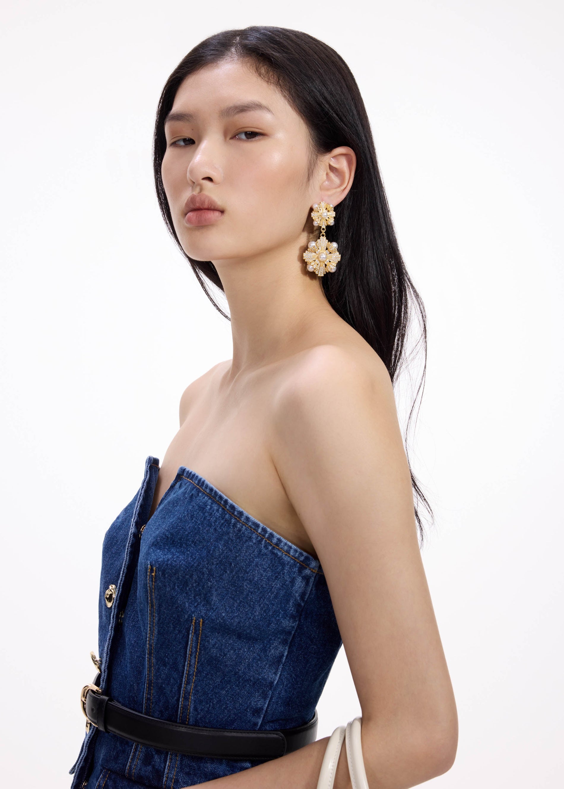 A close up of a woman wearing the Gold Encrusted Tiered Earrings