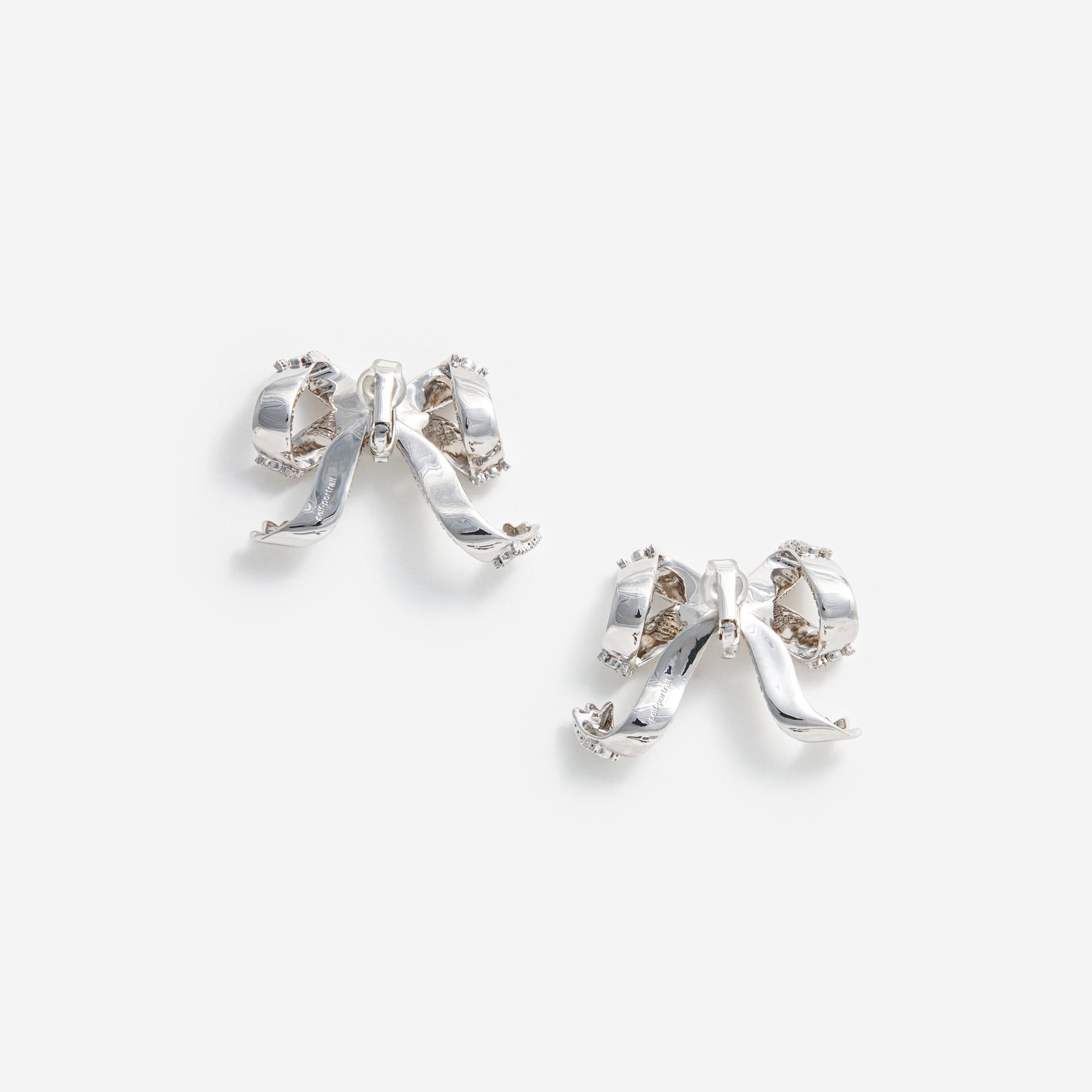 Side view of a woman wearing the Crystal Bow Earrings