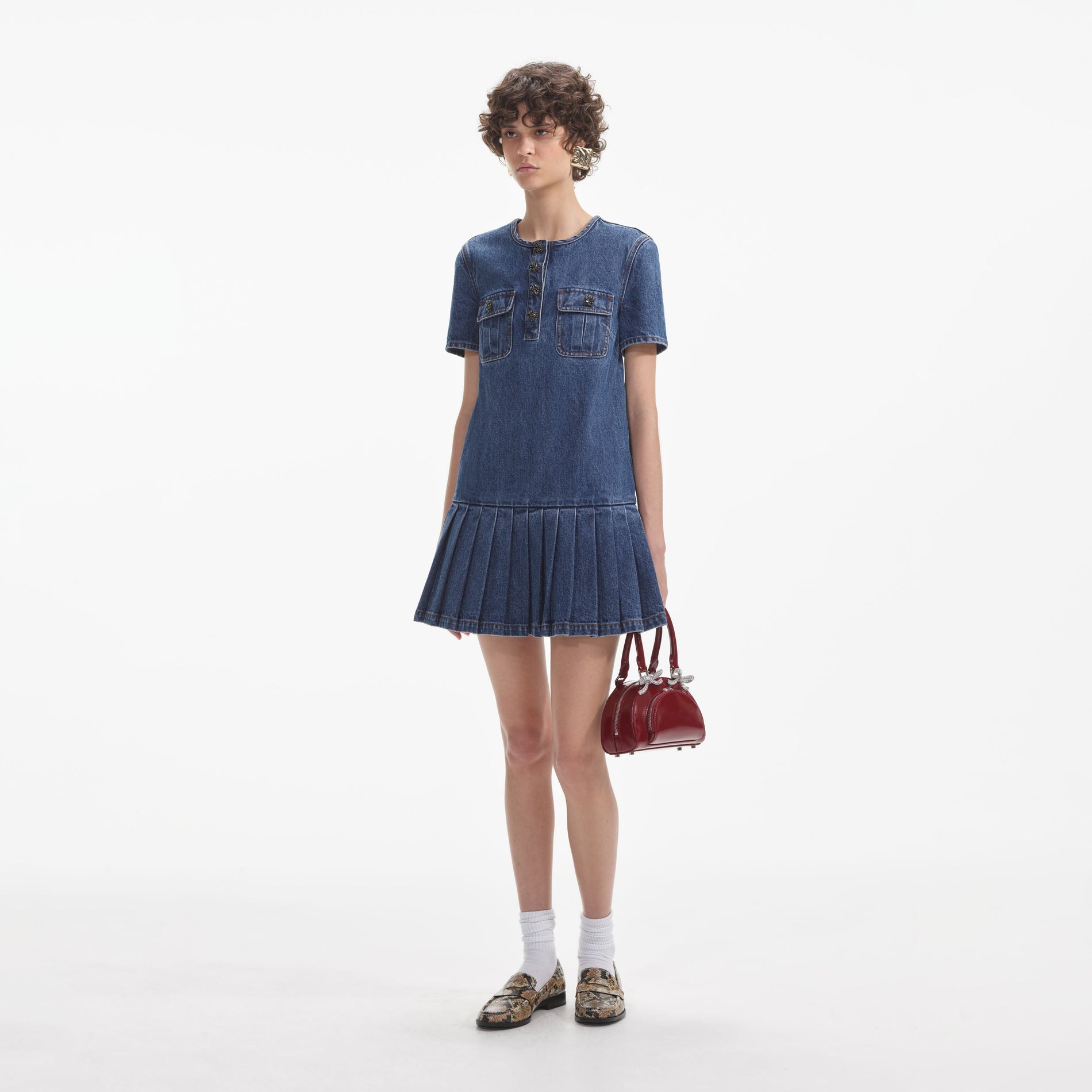 Side view of a woman wearing the Pleated Denim Mini Dress