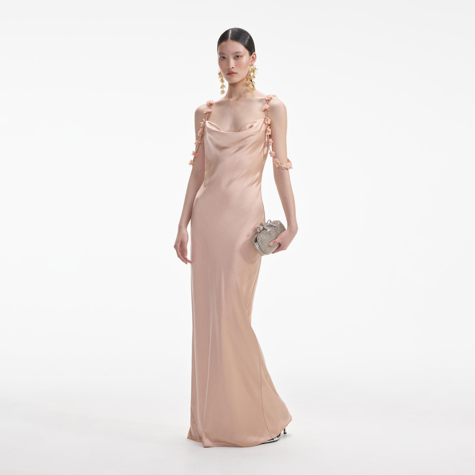 Side view of a woman wearing the Rose Gold Satin Flower Maxi Dress