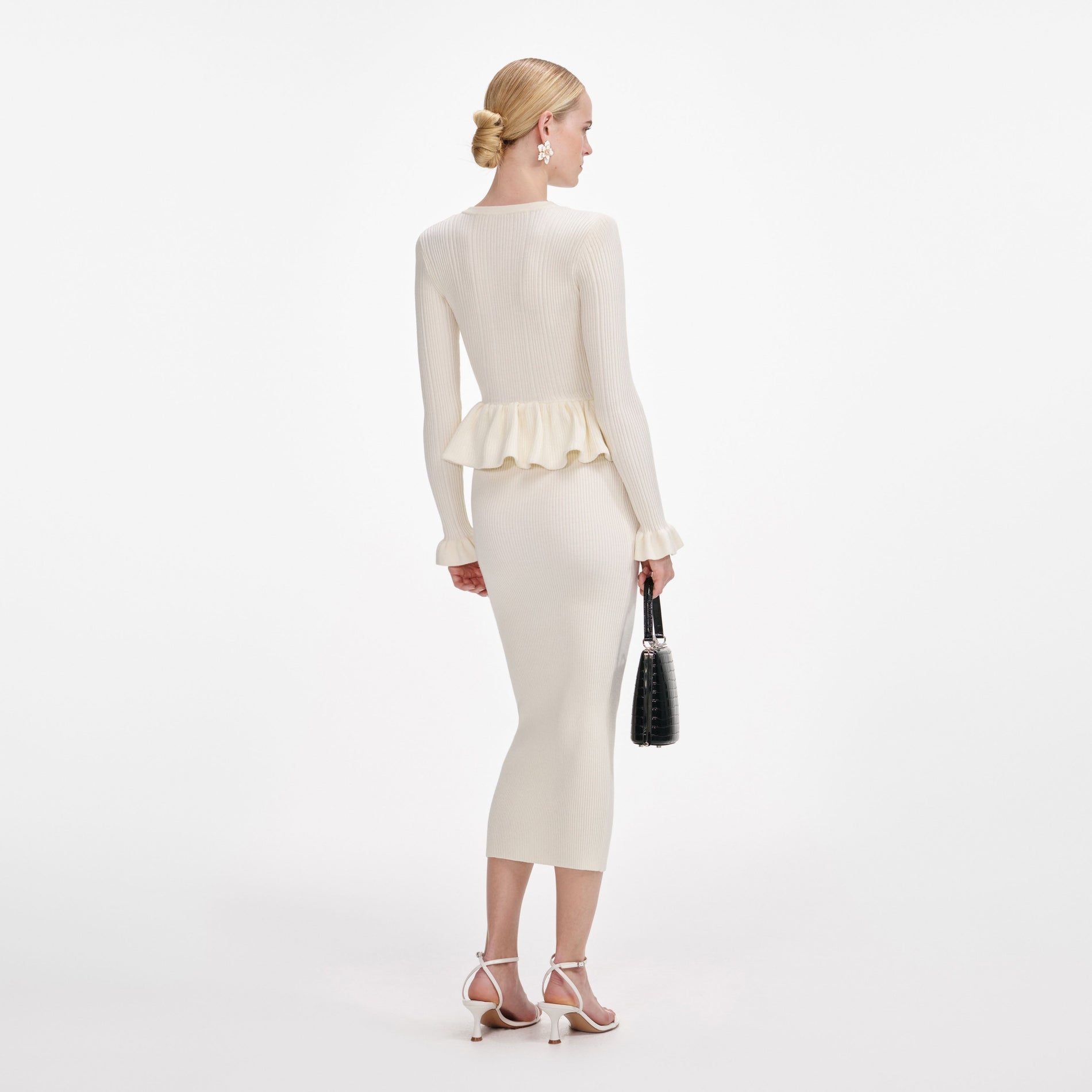Back view of a woman wearing the Cream Asymmetric Knit Midi Dress
