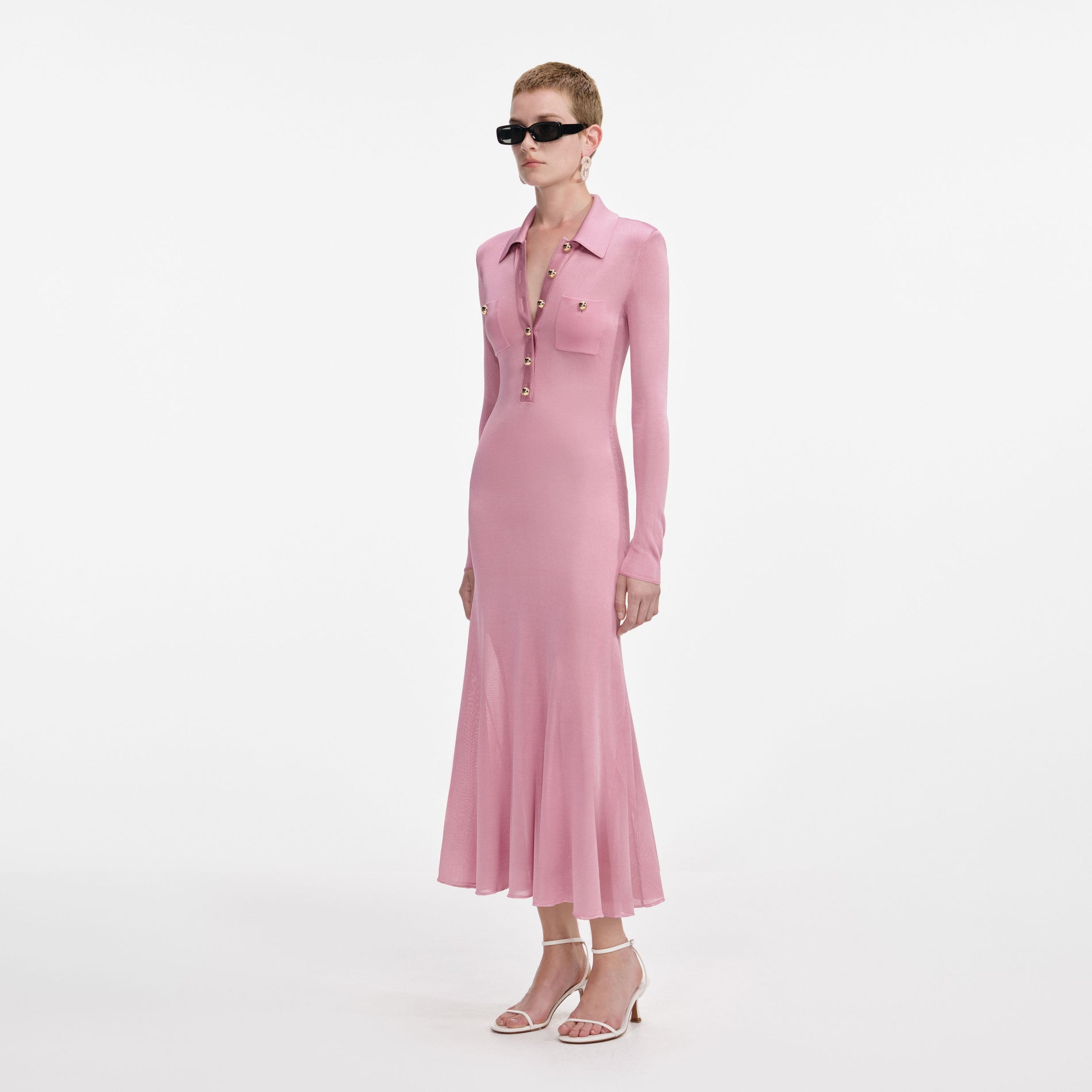 Side view of a woman wearing the Pink Viscose Knit Midi Dress