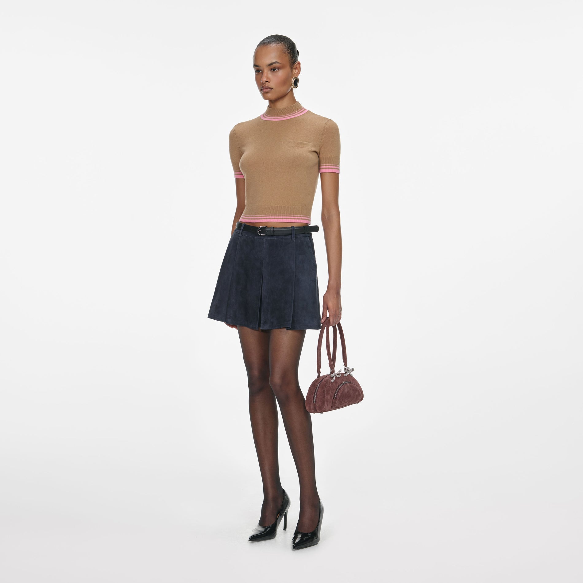 Side view of a woman wearing the Navy Suede Mini Skirt