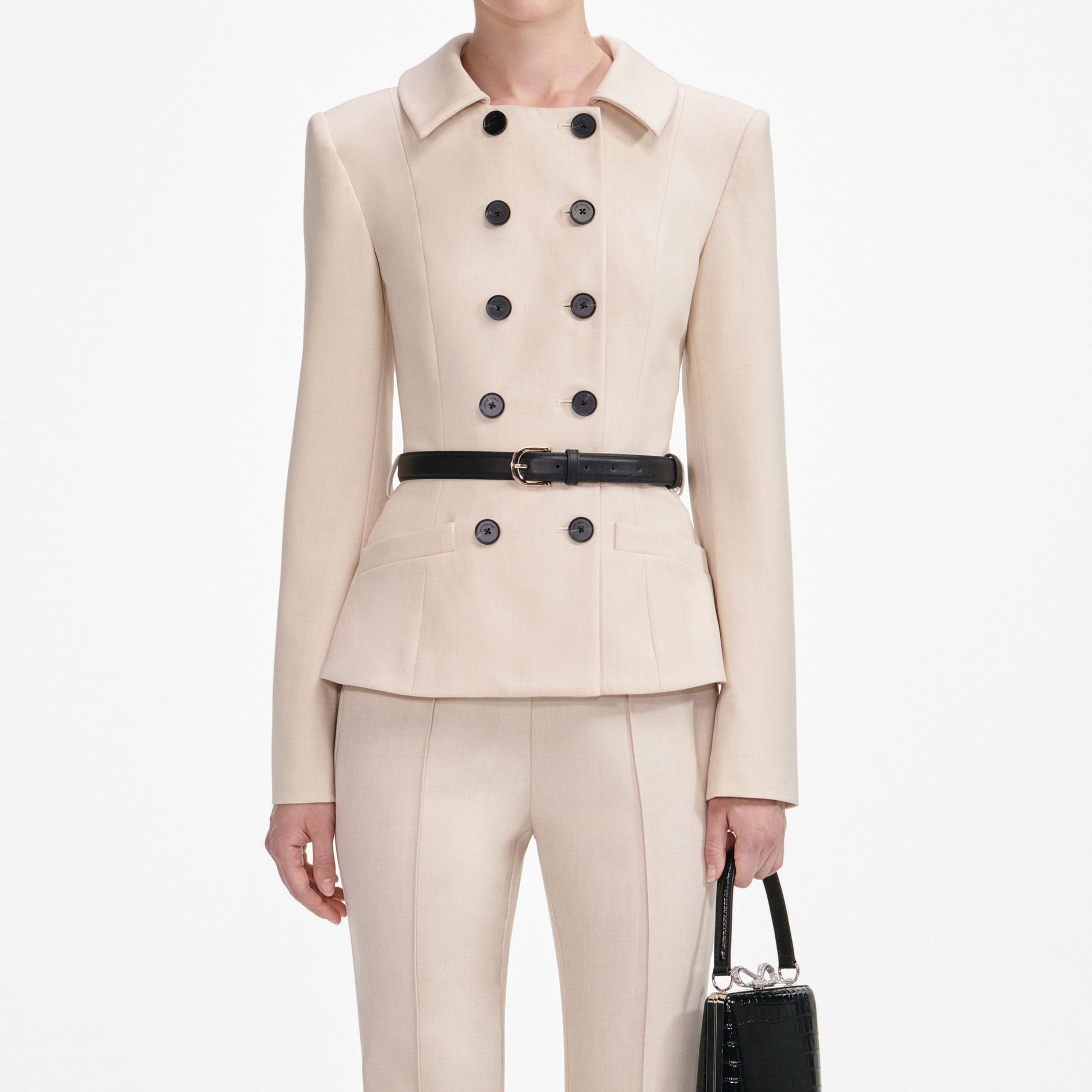 A close up of a woman wearing the Beige Twill Jumpsuit