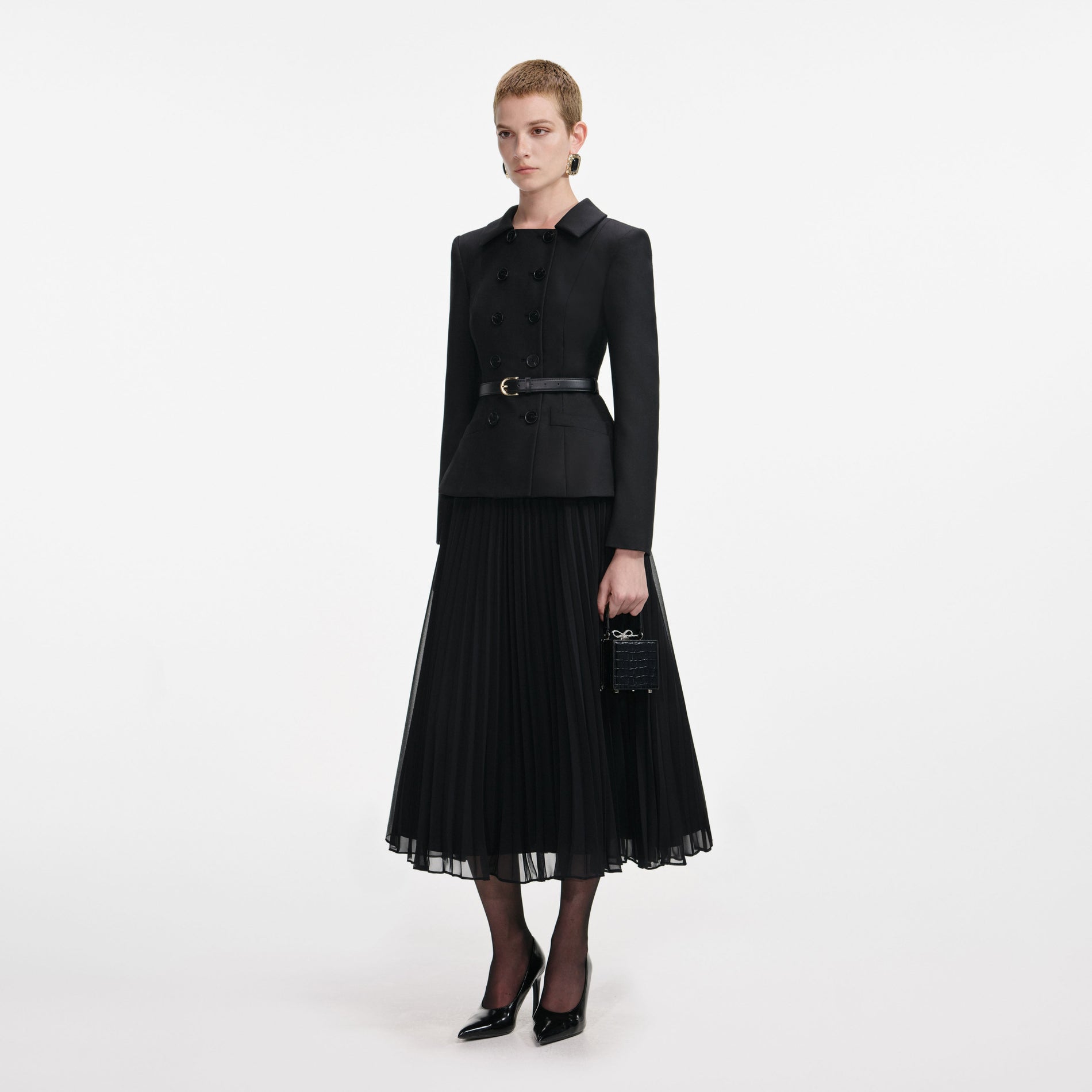 Side view of a woman wearing the Black Wool Crepe Midi Dress