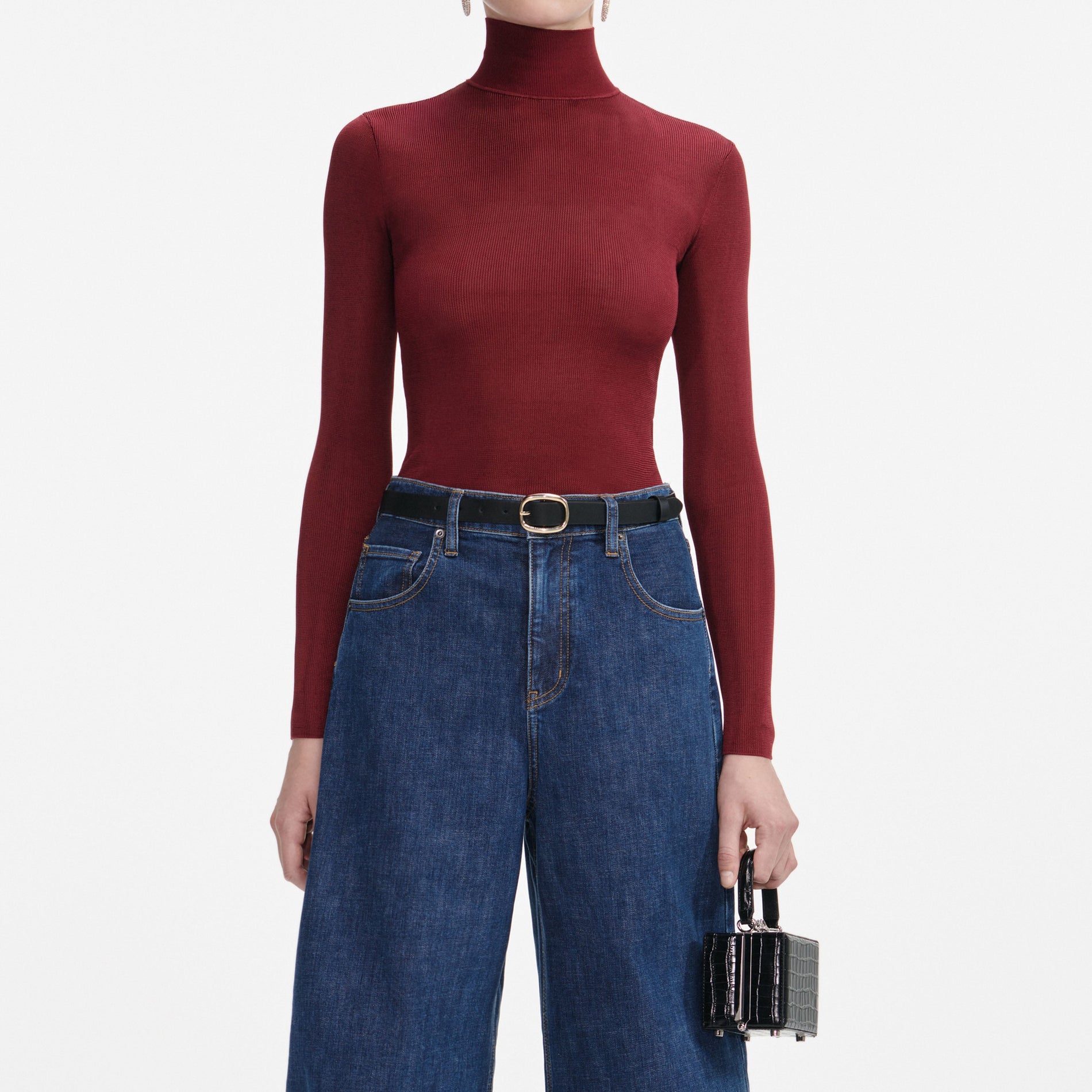 A close up of a woman wearing the Camel Peplum Knit Midi Dress