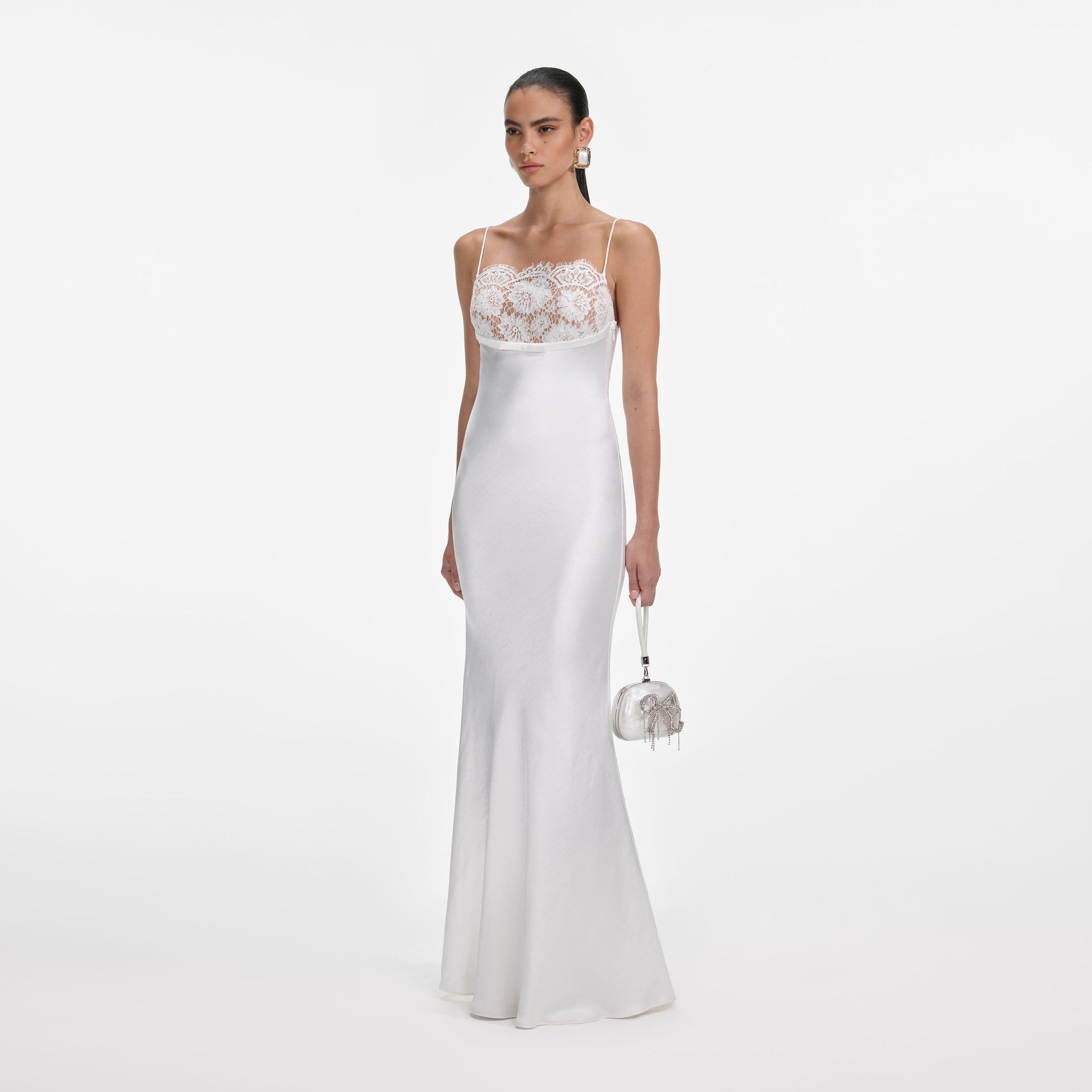 Side view of a woman wearing the White Satin Lace Maxi Dress