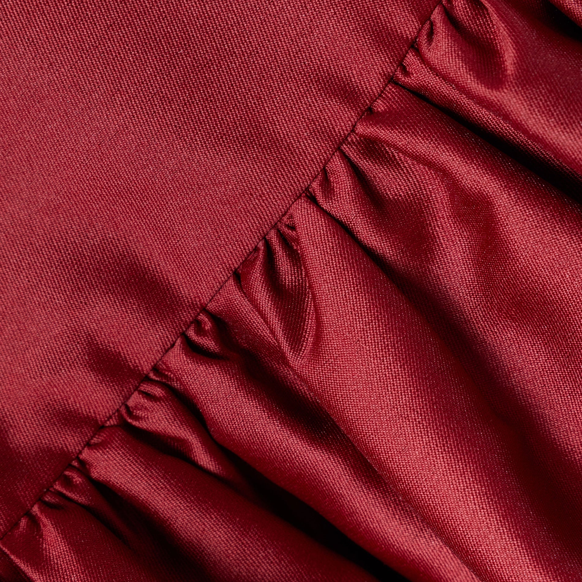 Close up of a red fabric with pleats